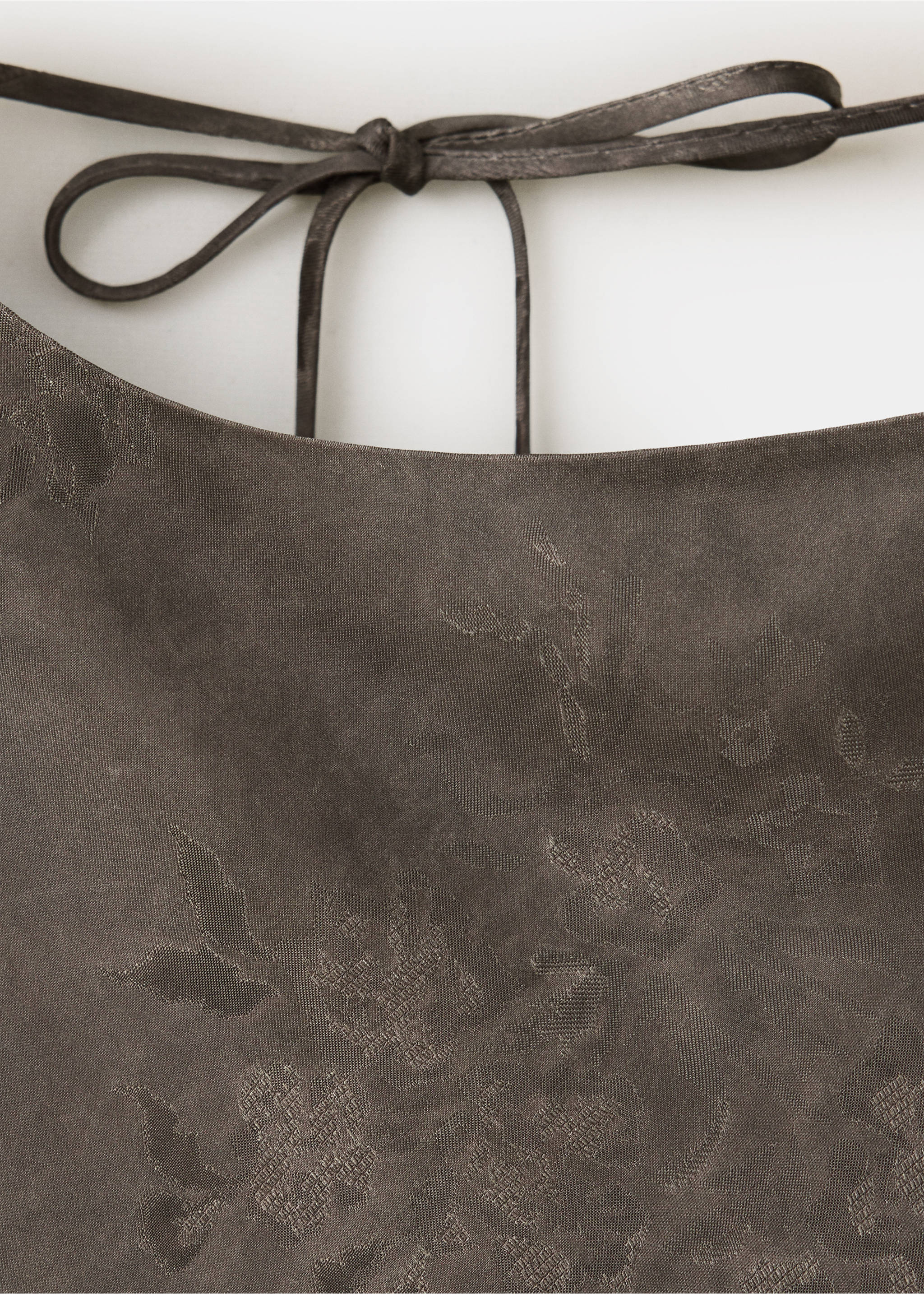 Dark brown dress detail with tonal floral pattern and tie straps., Brown. Ref: 37029125-00.