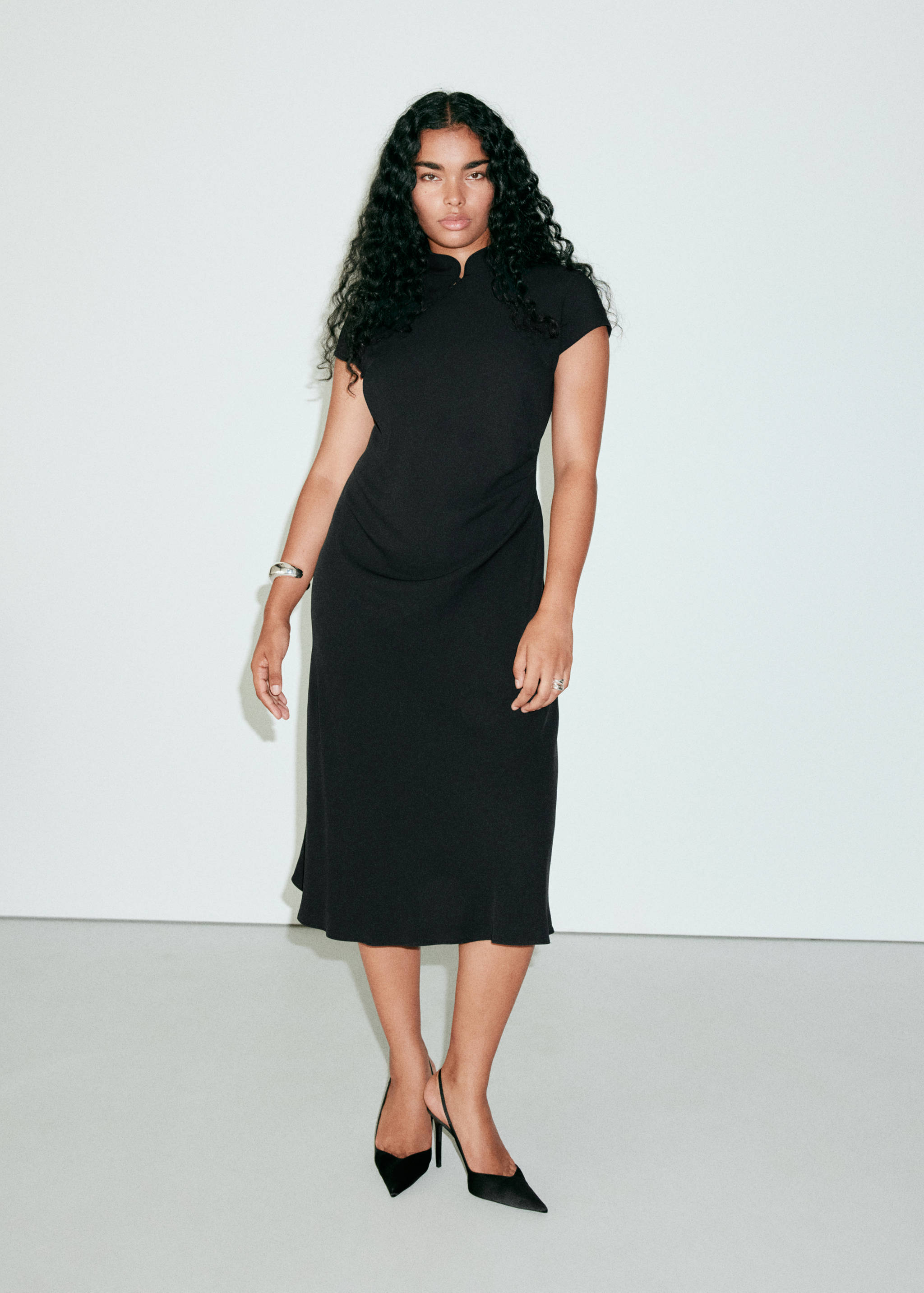 Black midi dress featuring short sleeves, a mandarin collar, and a fitted silhouette.