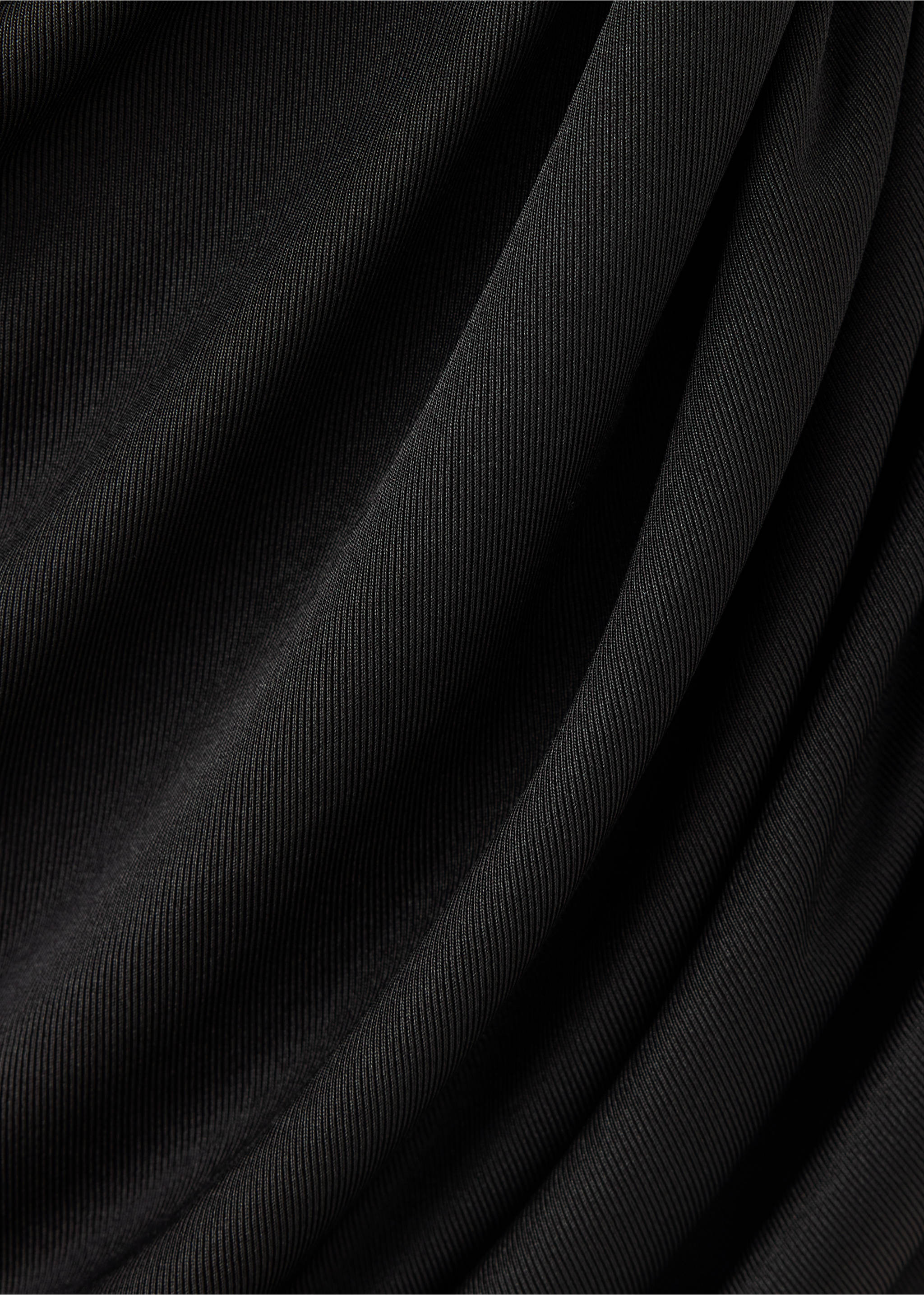 Close-up of a black ribbed top detail showing soft draping., Black. Ref: 37029132-00.