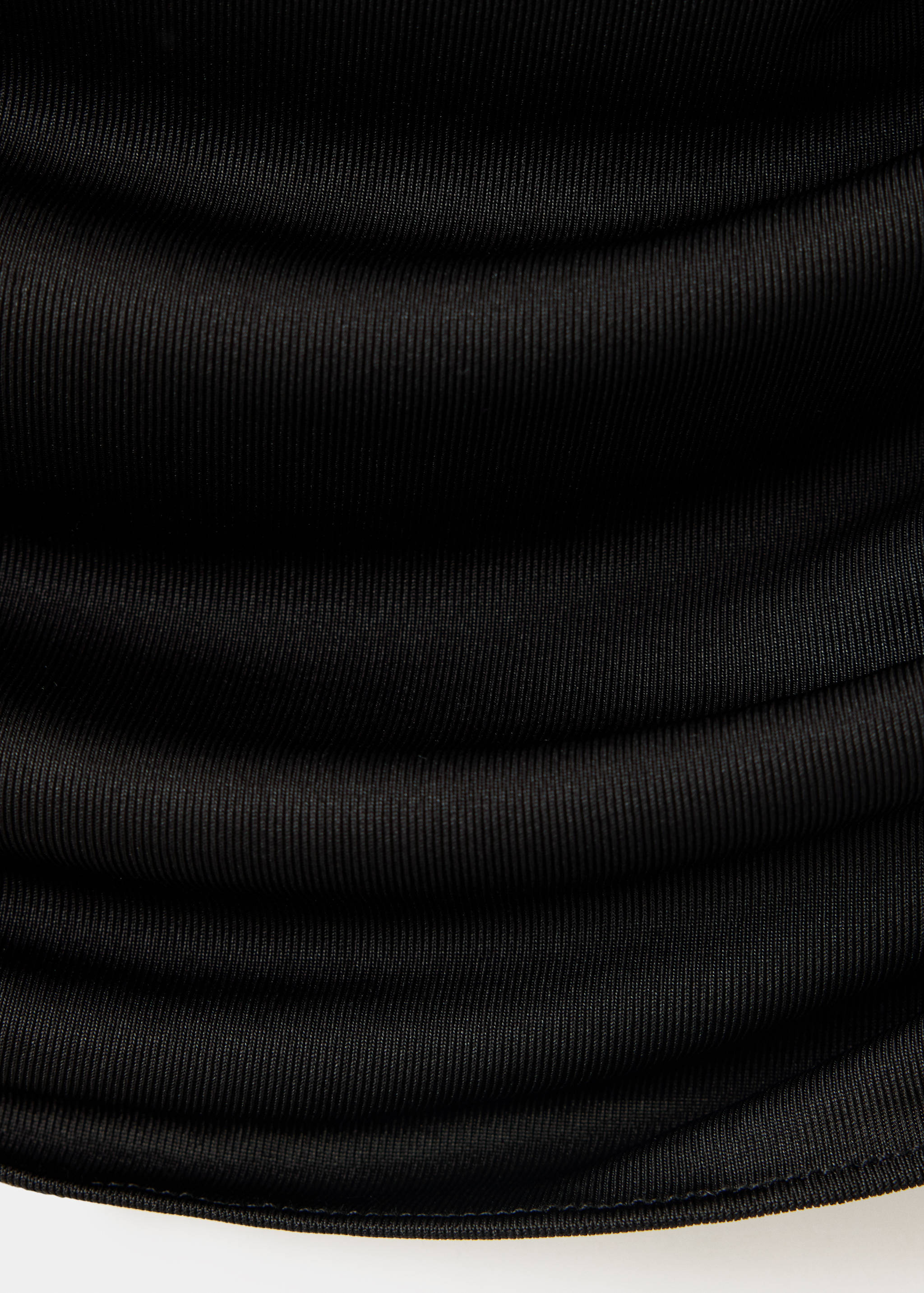 Close-up of the black ribbed top fabric detail.