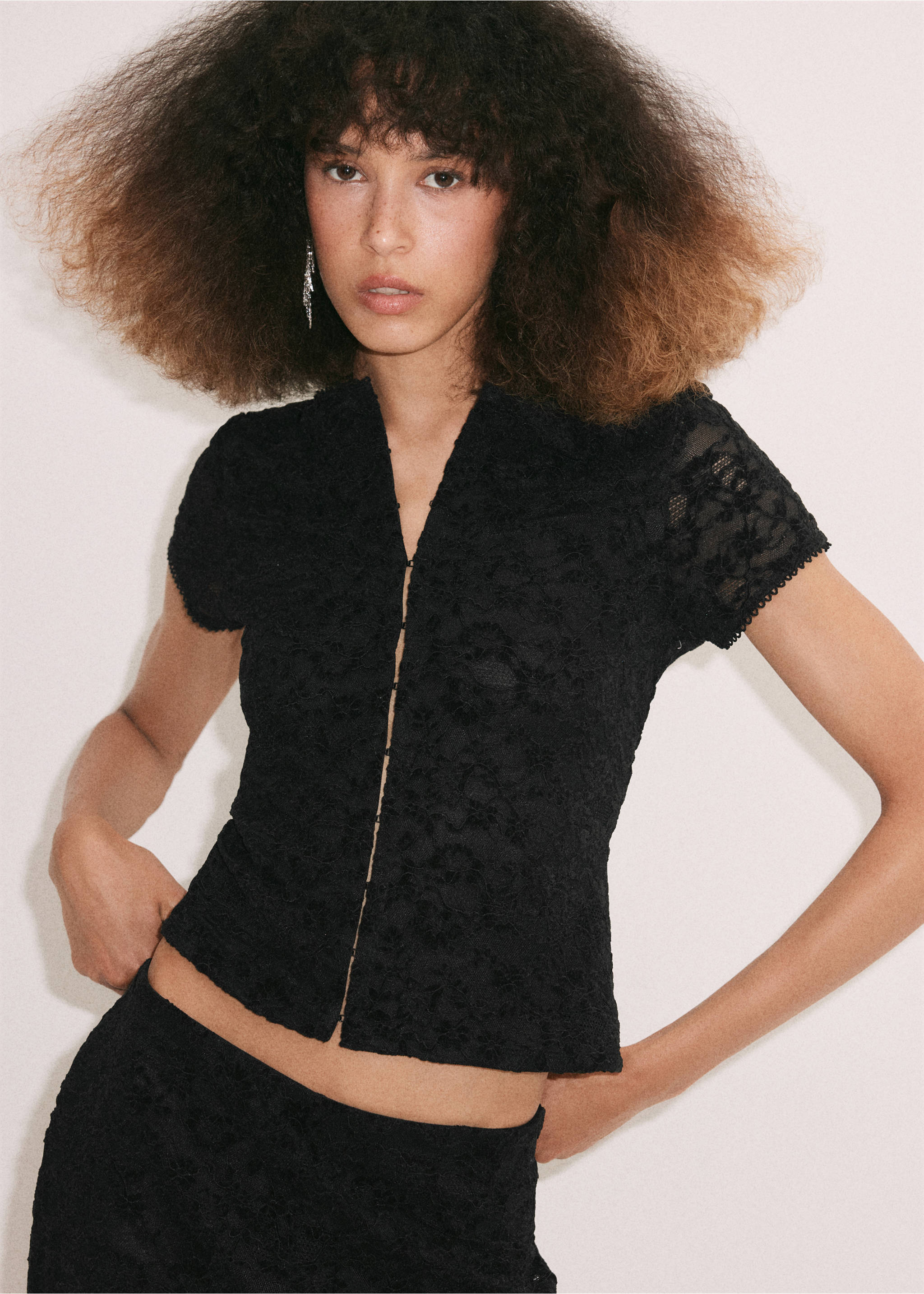 Black lace short-sleeve top with a V-neck and button front., Black. Ref: 37029134-00.