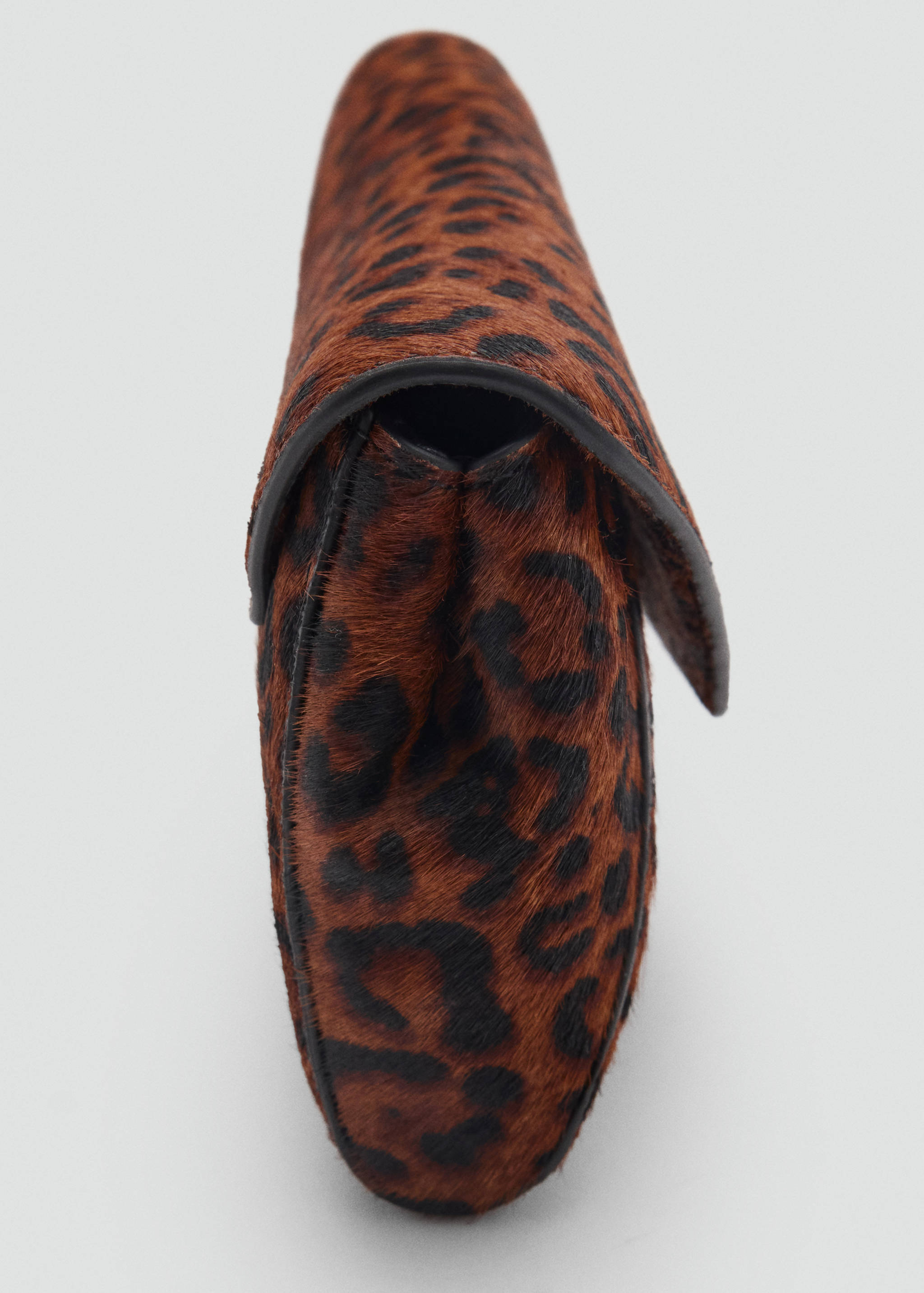 Close-up of a brown and black faux-fur animal print handbag, showing the side profile and textured finish.