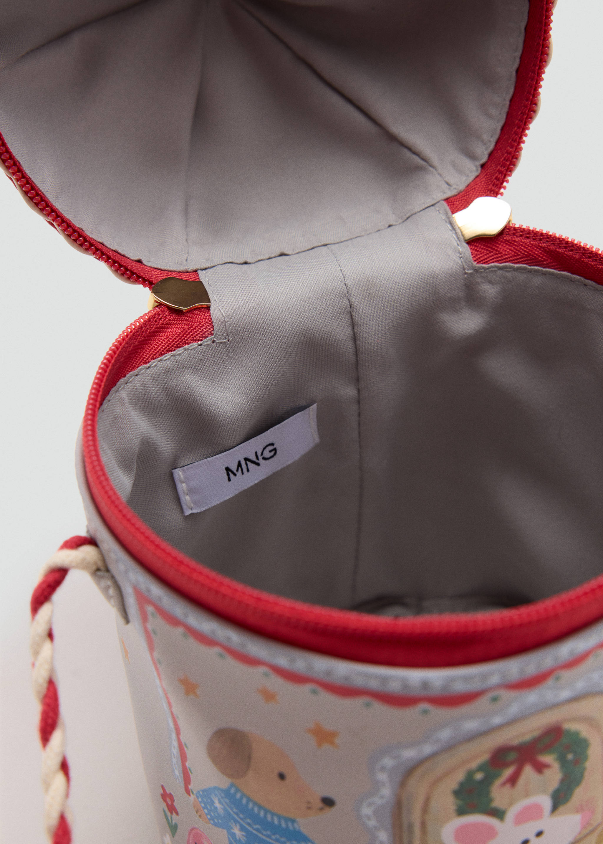 Close-up of an open cylindrical children's bag interior with grey lining and MNG label.