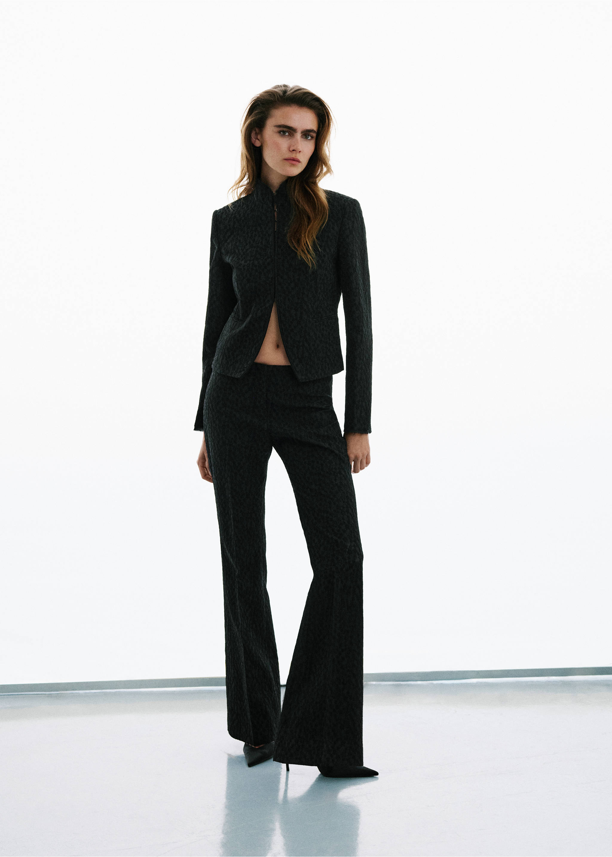 Dark patterned jacket with a high collar and front zip, worn with matching trousers., Black. Ref: 37029404-00.