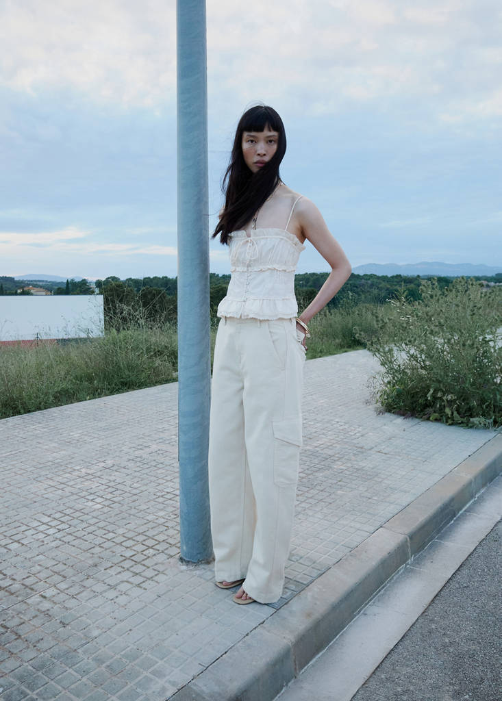Ruffled top with embroidered details — Ecru