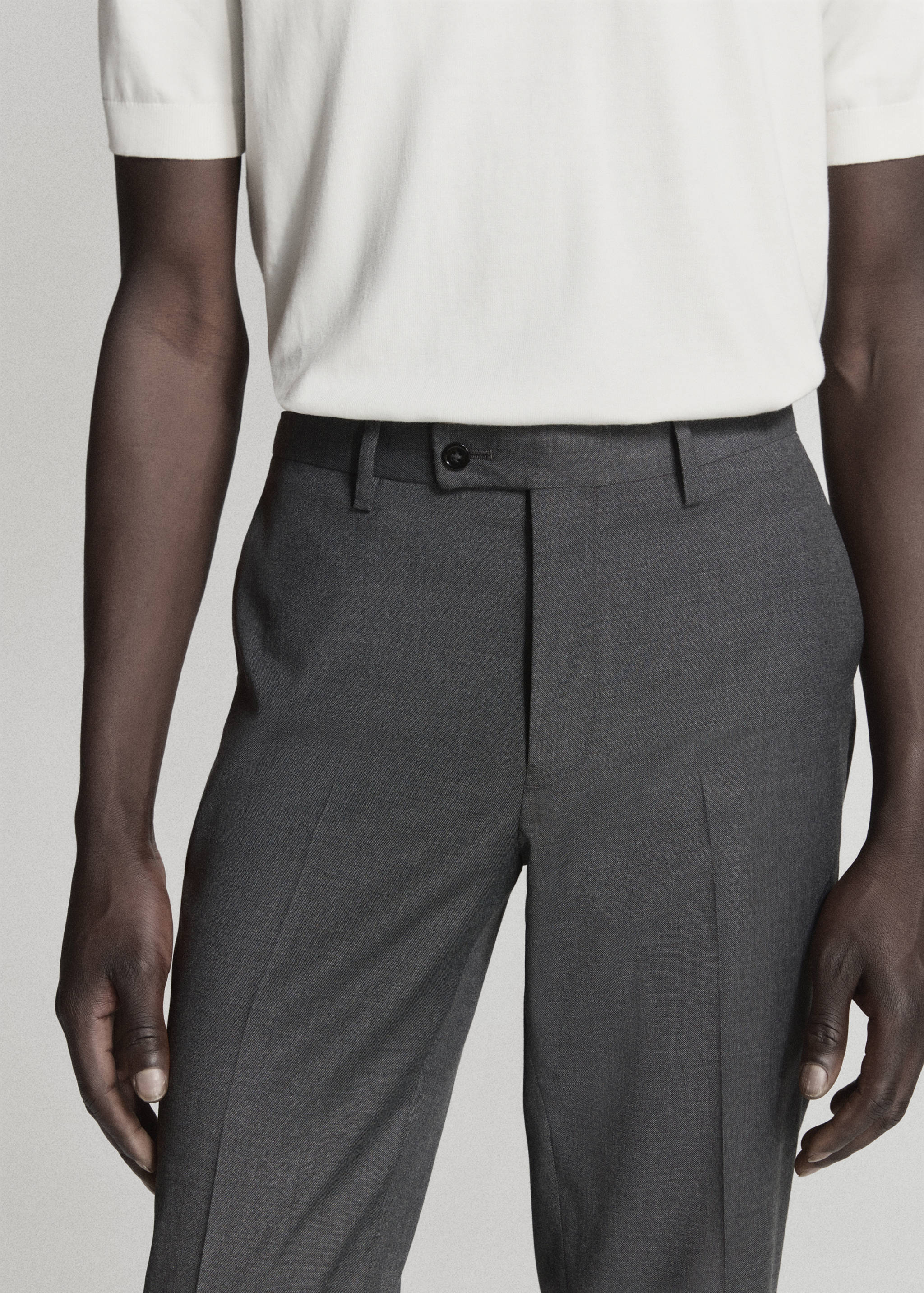 Dark grey trousers with a buttoned waistband and belt loops.