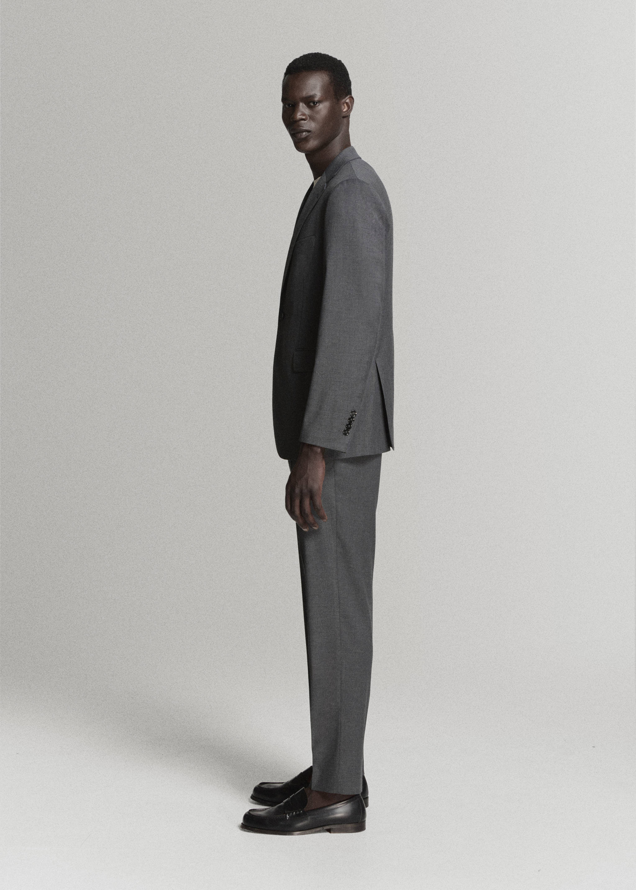 Grey slim-fit trousers worn as part of a matching suit.
