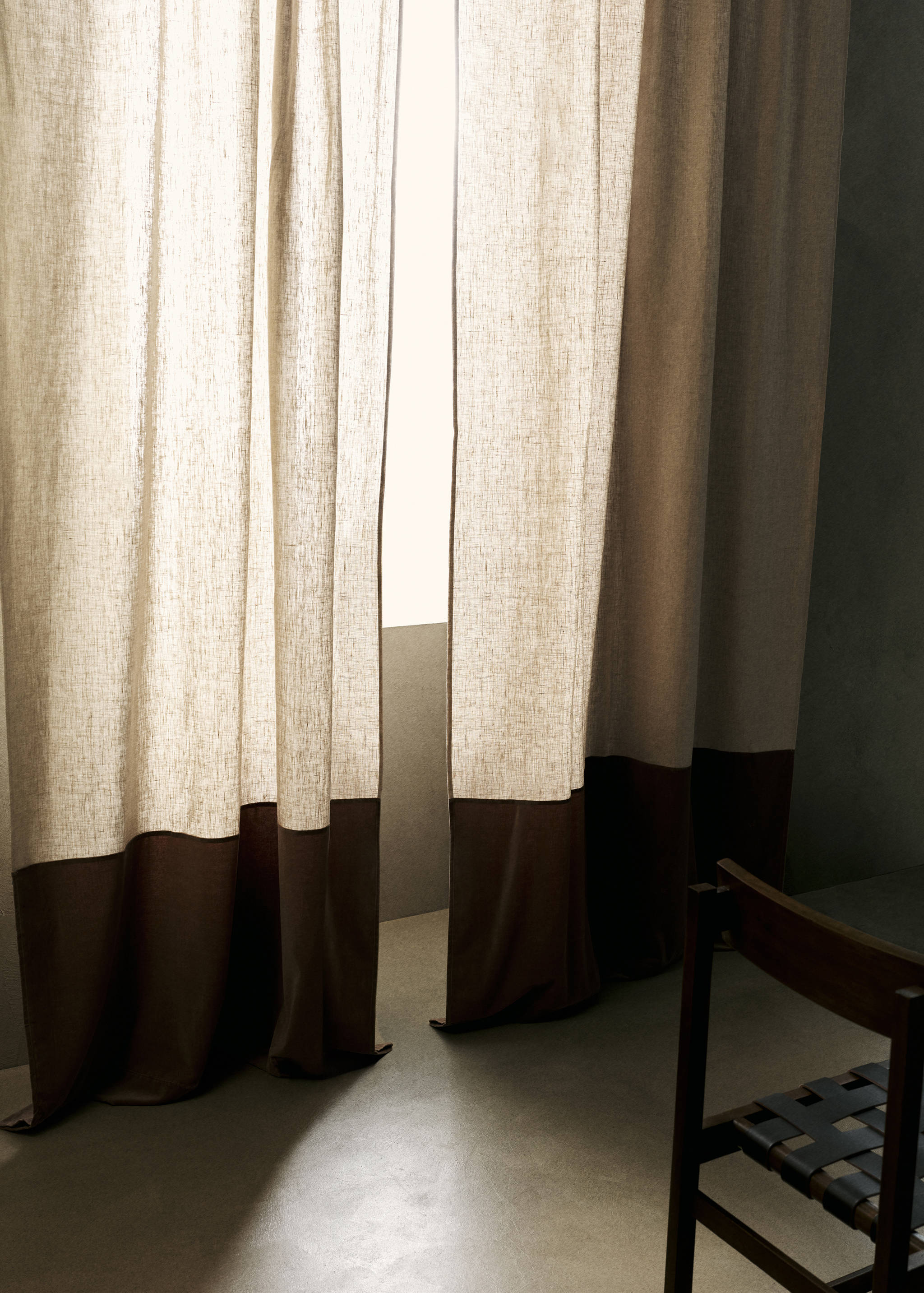 Natural linen-blend curtain featuring a contrasting dark brown colour block hem.