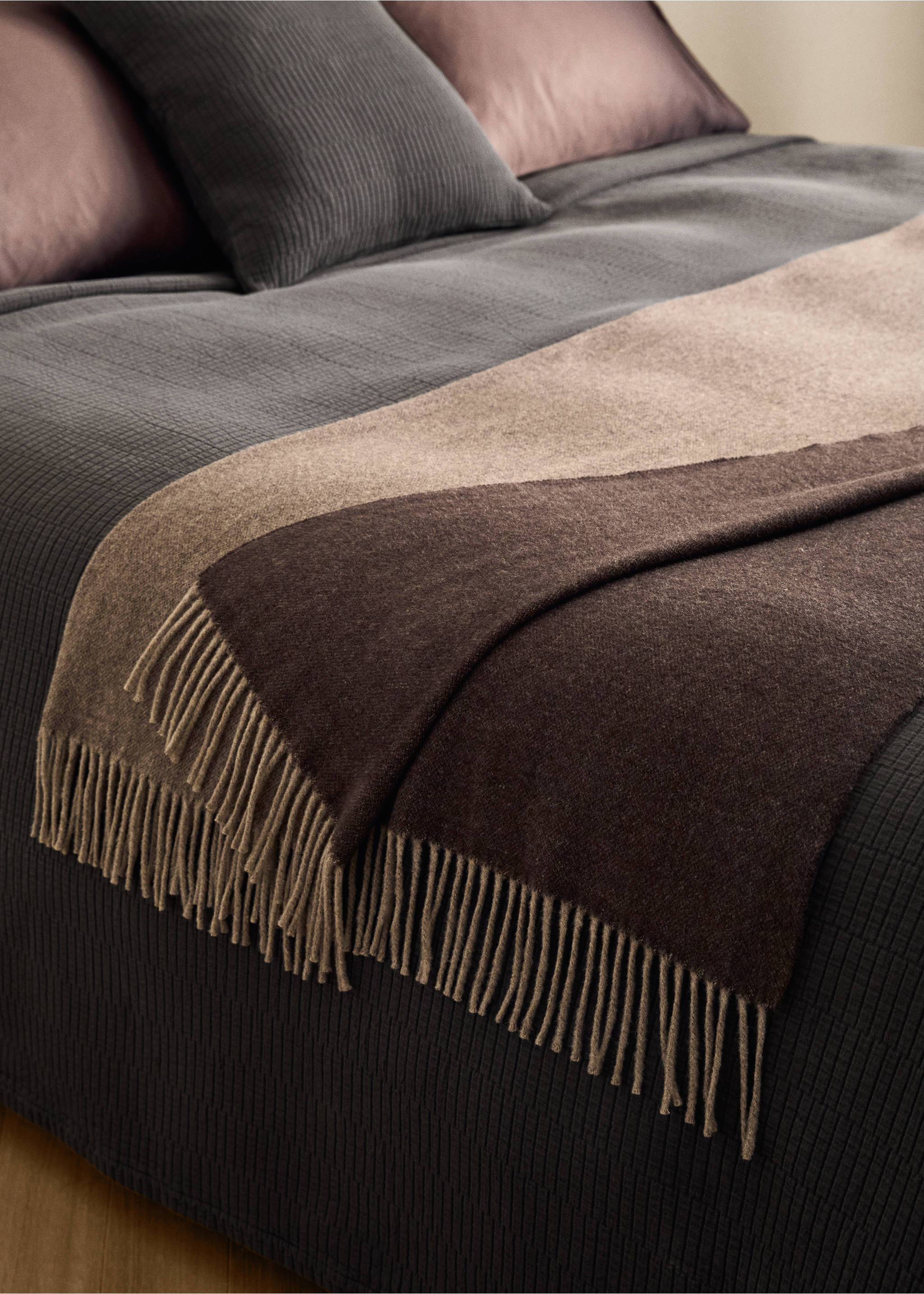 Color-blocked blanket in dark brown, taupe and beige with fringing, draped on a bed., Light/Pastel Brown. Ref: 37032555-00.