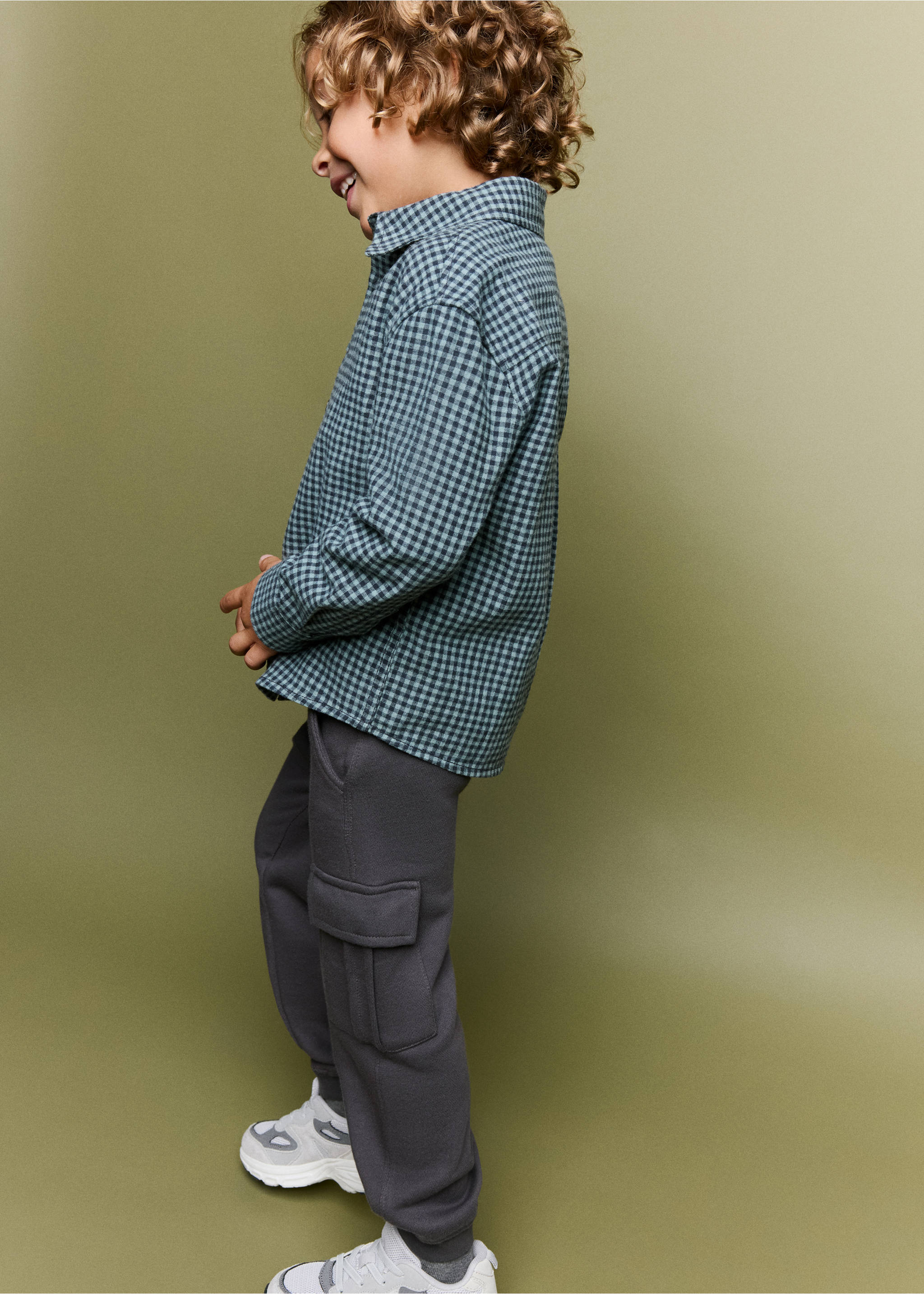 Dark grey cargo trousers worn by a child with a checked shirt., Charcoal. Ref: 37033308-00.