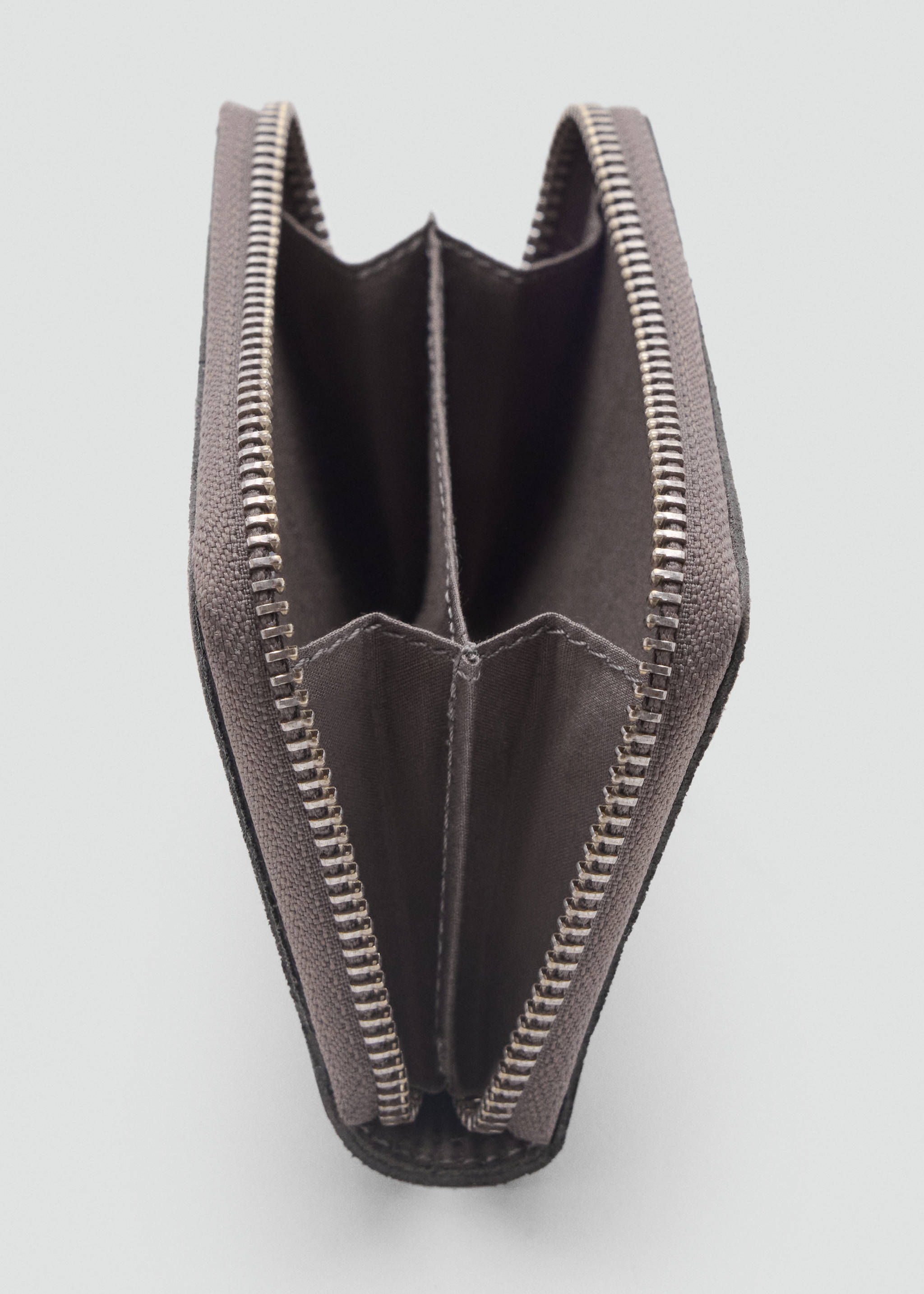 Close-up of an open grey wallet showing its zipped compartment details.