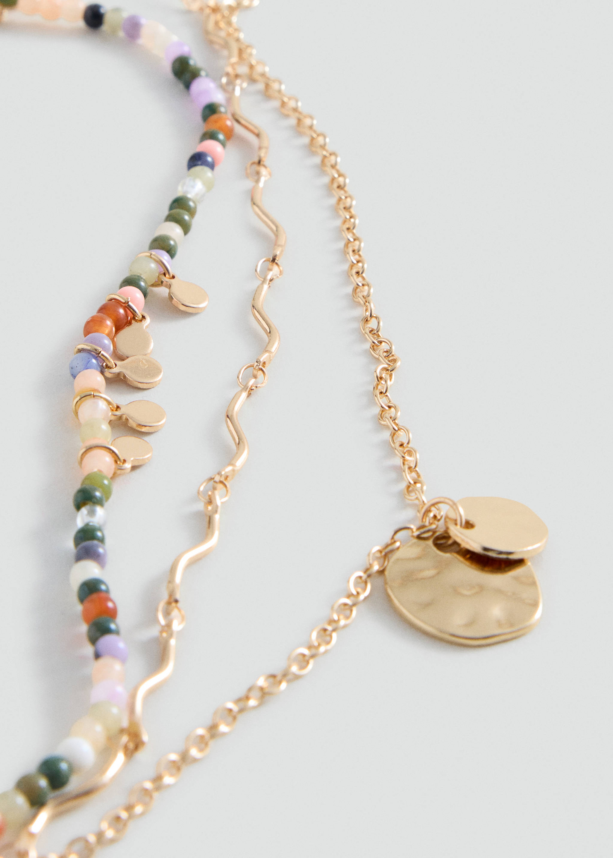 Multi-strand necklace with multicolored beads and gold chains with disc charms.