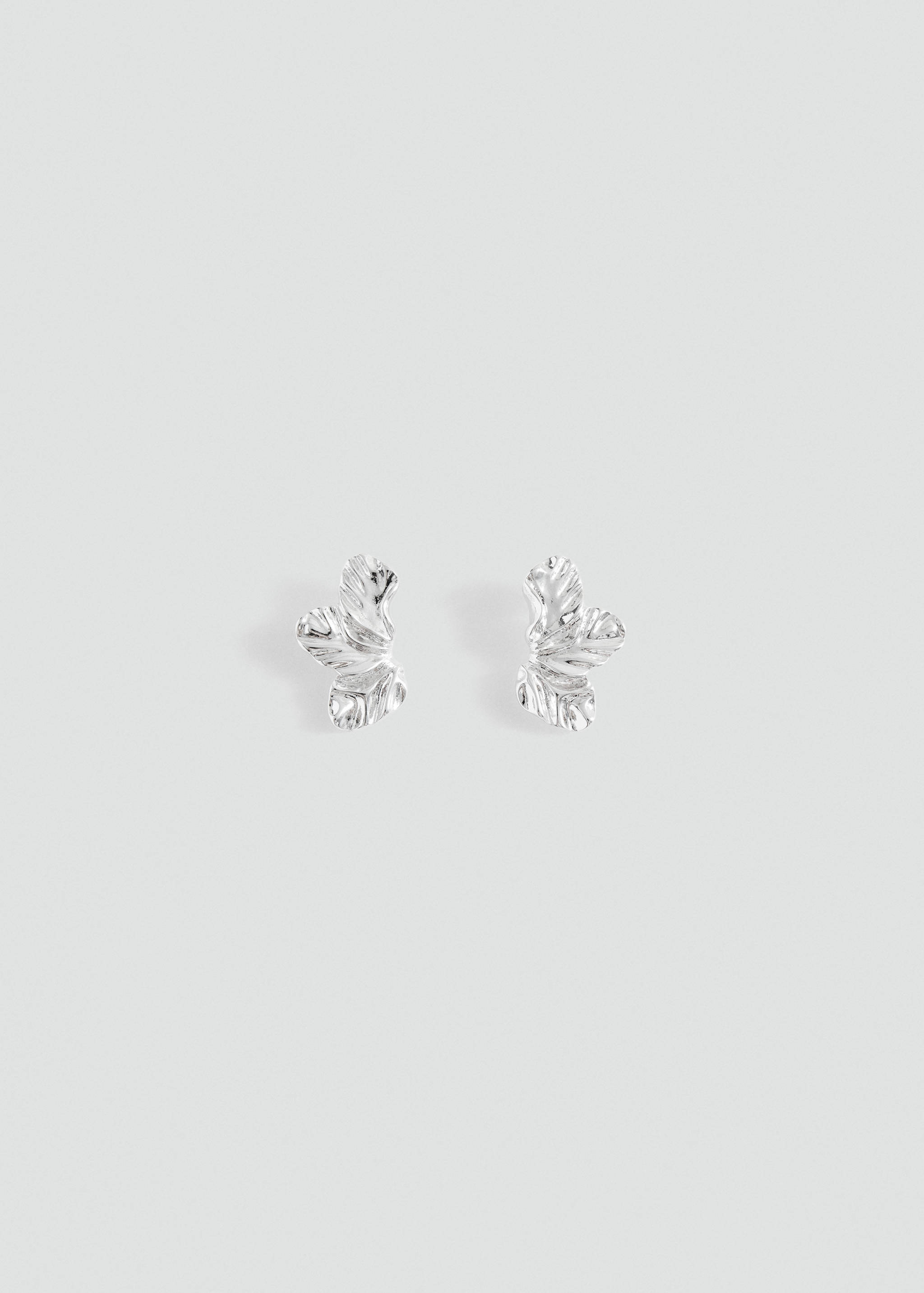 Silver-coloured earrings with an organic, textured sculptural design.