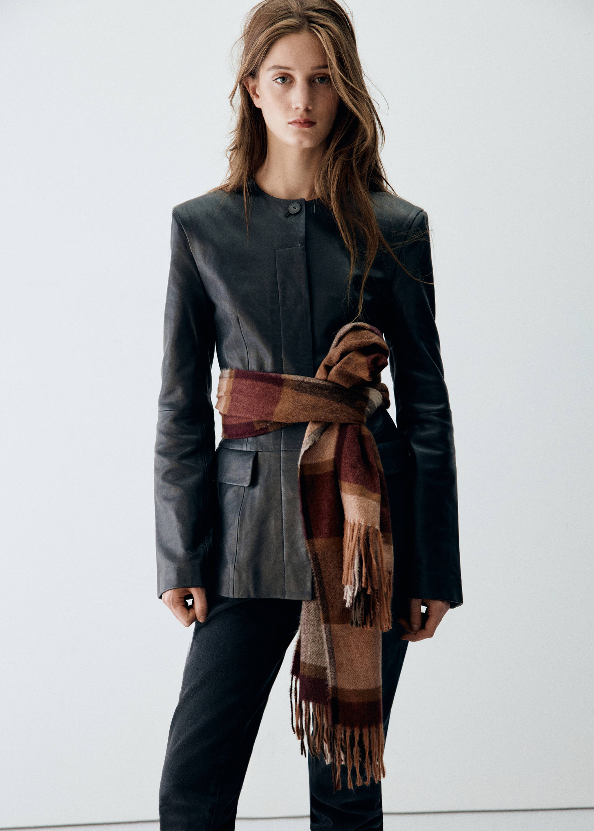 Brown checked scarf wrapped around the waist as a belt.