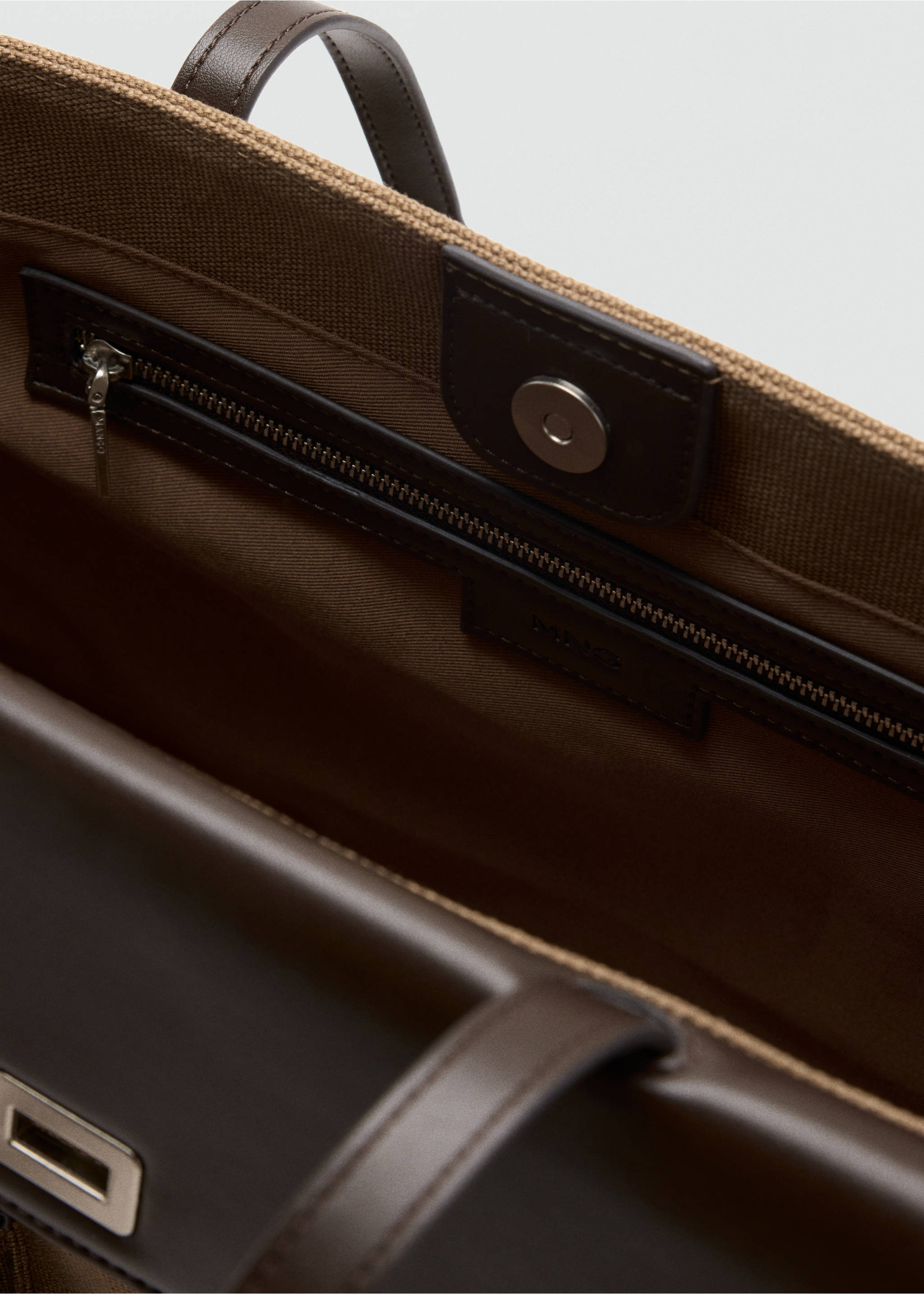 Close-up of the interior of a brown tote bag showing the zipped pocket and snap closure., Khaki. Ref: 37036011-00.