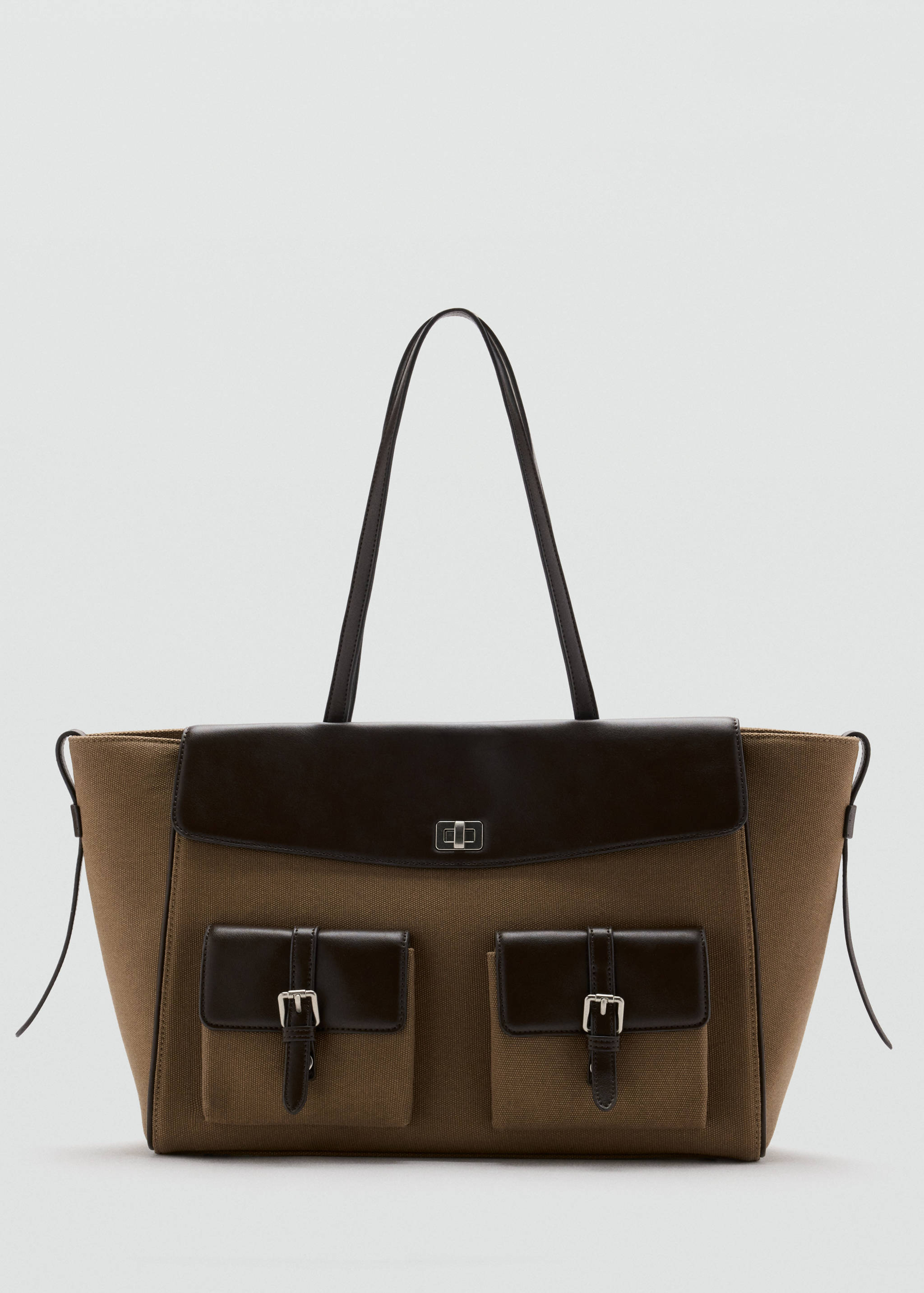 Brown canvas tote bag with dark brown contrast flap, pockets, and shoulder straps.