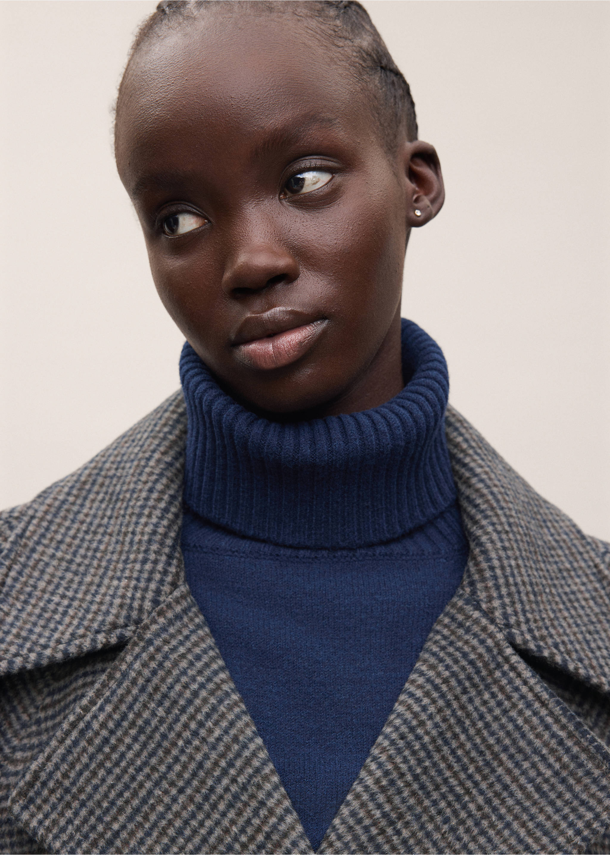 Close-up of a patterned coat with wide lapels and a blue ribbed turtleneck., Sand. Ref: 37036321-01.