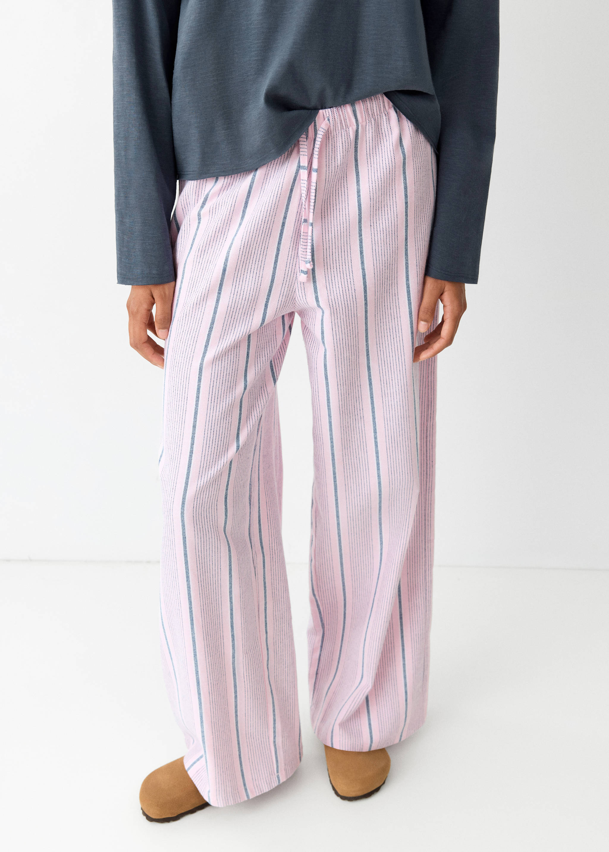 Pink striped pyjama trousers with an elasticated drawstring waist and a relaxed fit.