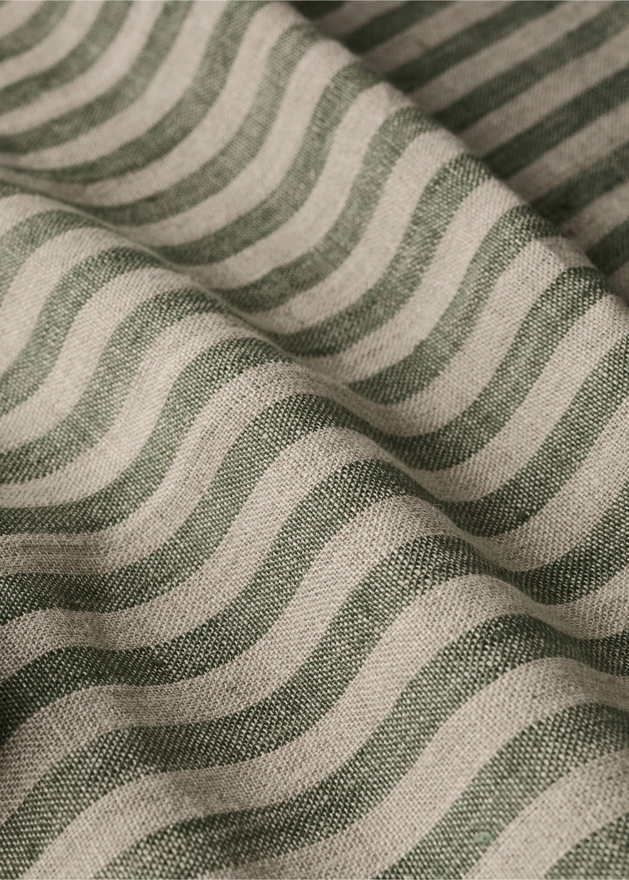 Close-up of a green and off-white striped fabric napkin detail., Green. Ref: 37036734-00.