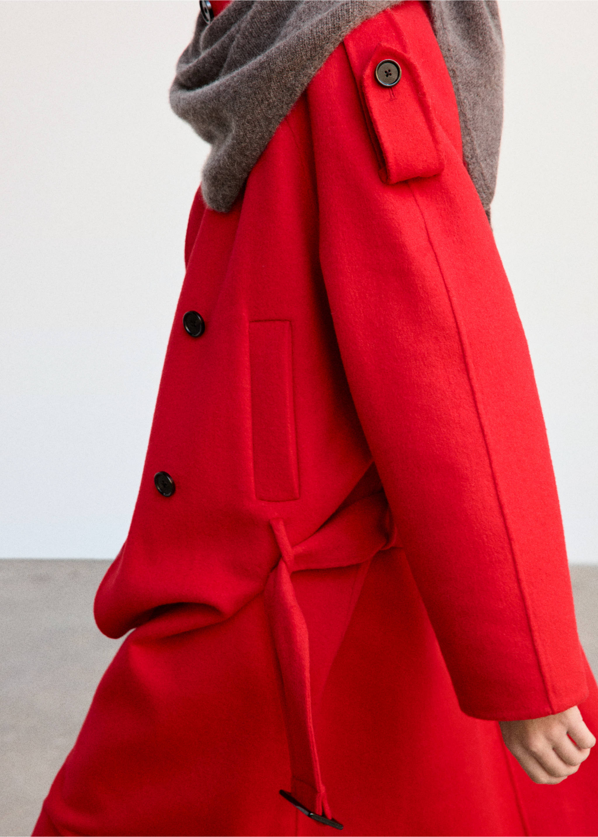 Close-up of a red coat with a self-tie belt and dark buttons., Red. Ref: 37036740-01.