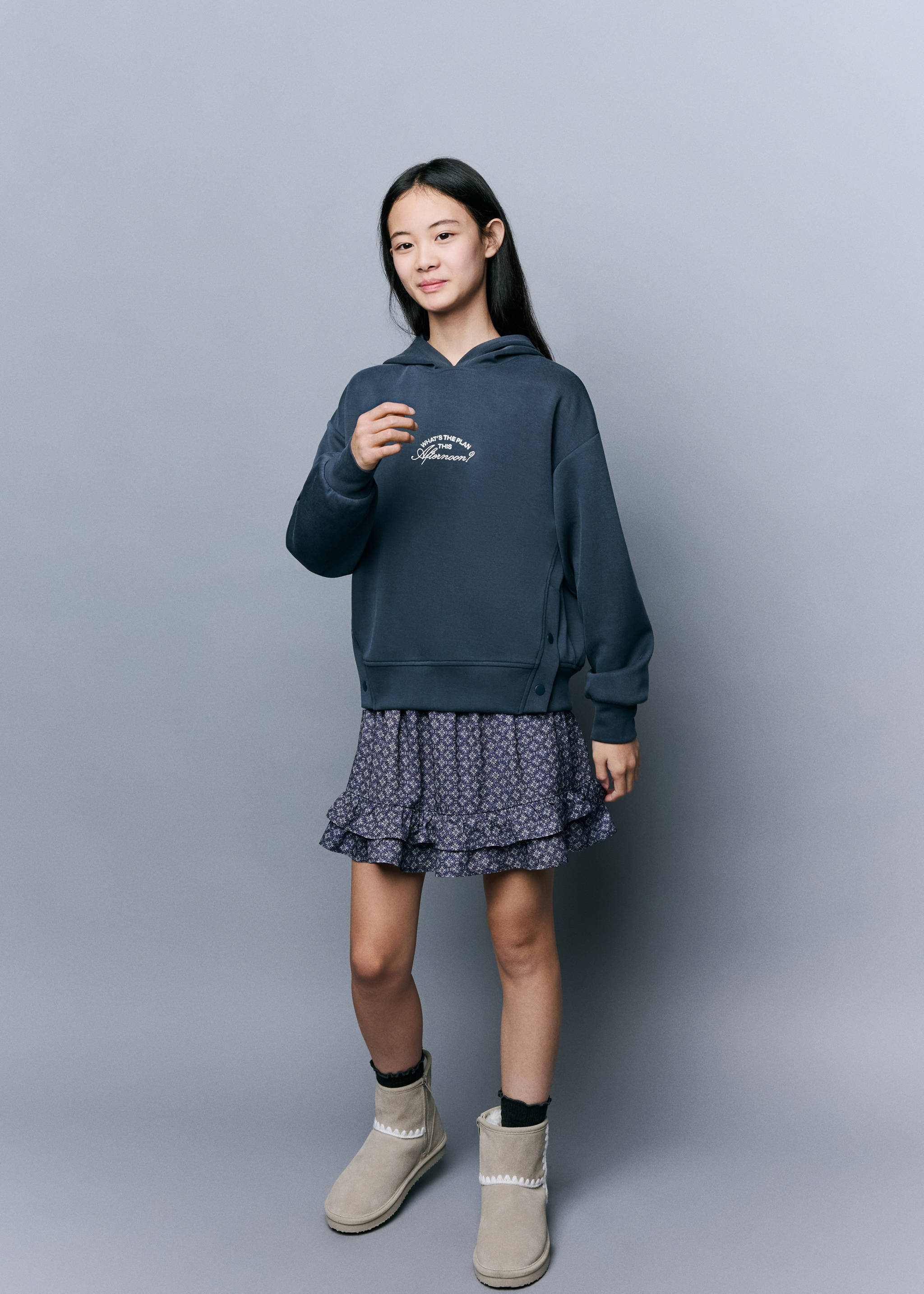 Dark grey-blue hooded sweatshirt with a white chest graphic and side button details.
