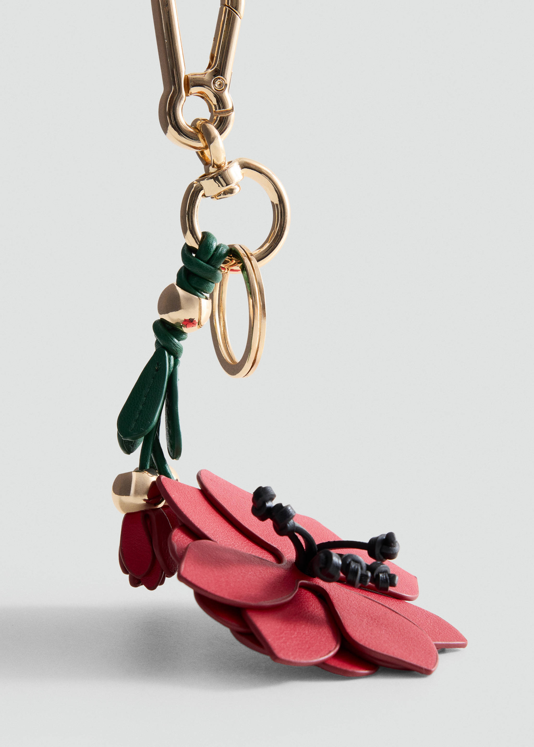 Red floral keychain with gold-tone hardware and green details.