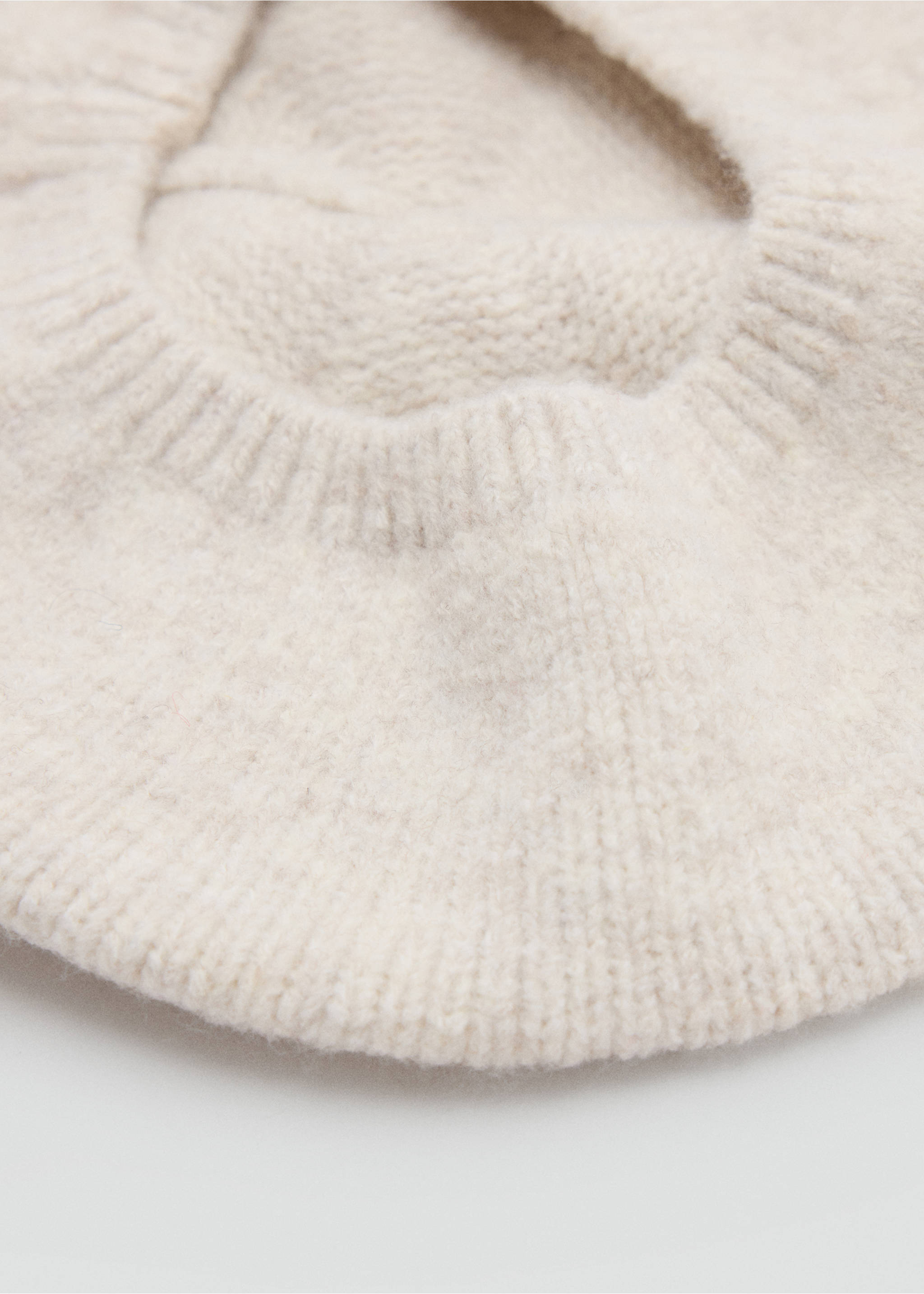 Close-up of a soft off-white knitted beanie highlighting its textured ribbed knit., Ecru. Ref: 37037120-00.