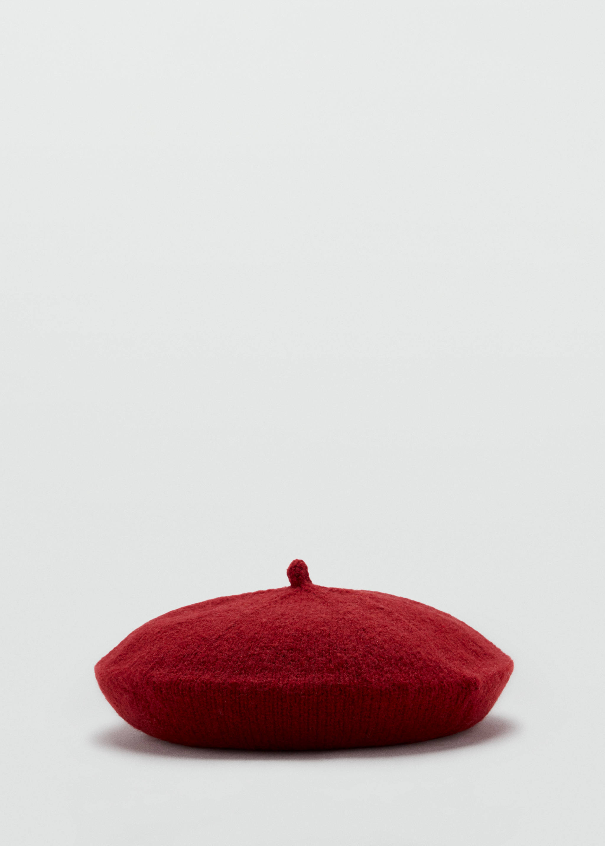 Red knitted beret with a textured finish and small top stem.