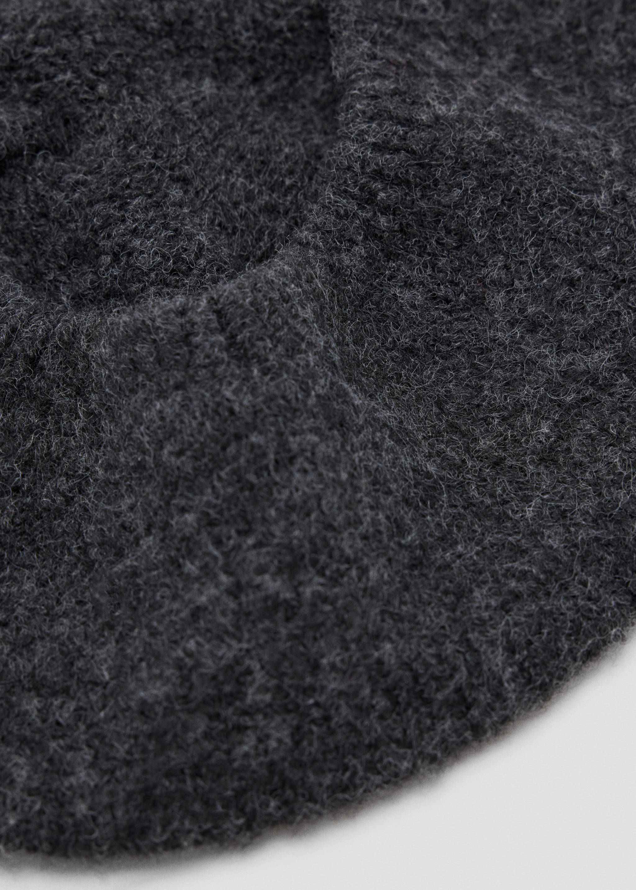 Dark grey fuzzy knit hat, close-up.