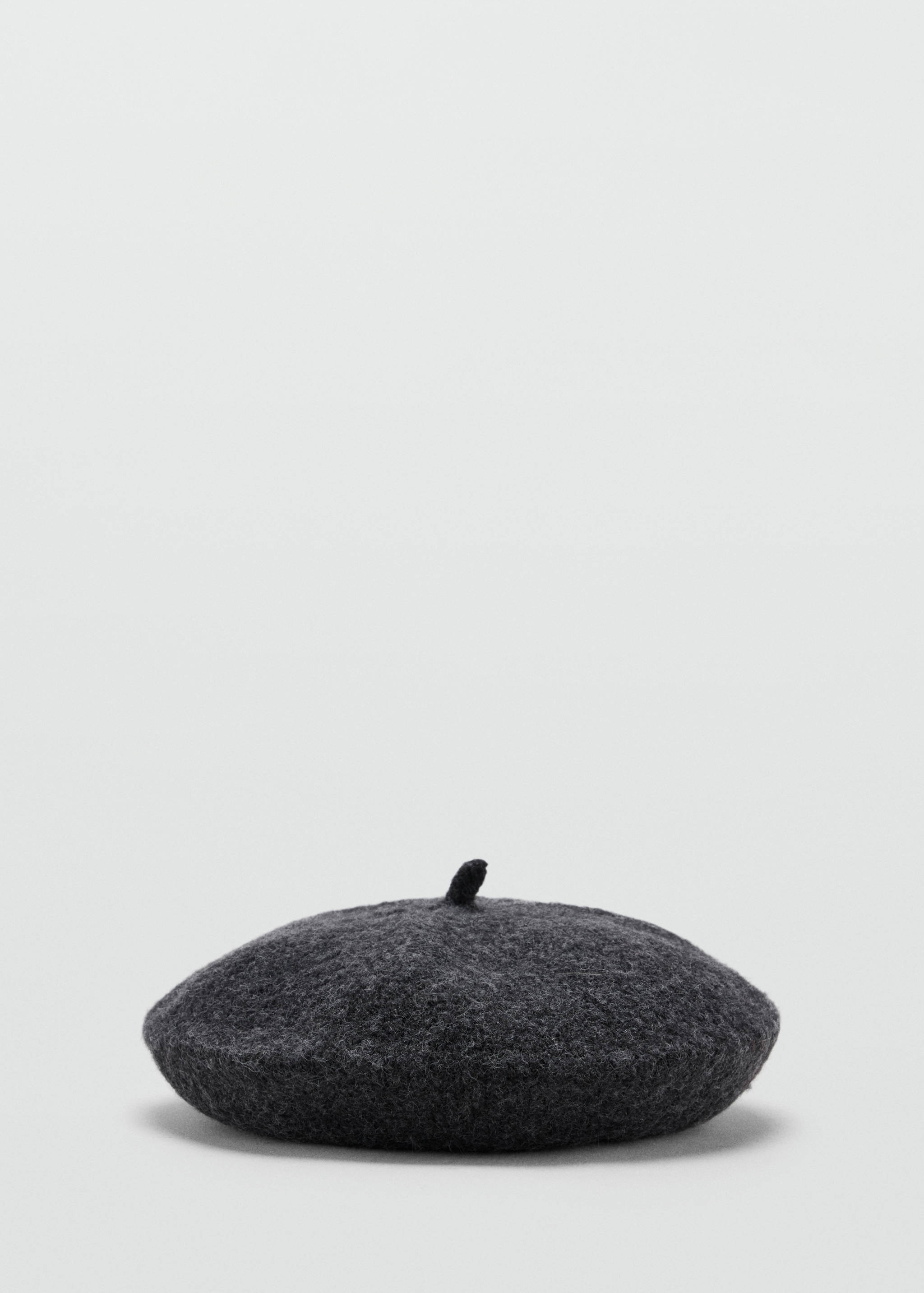 Charcoal grey wool beret with a felted texture and top stem.