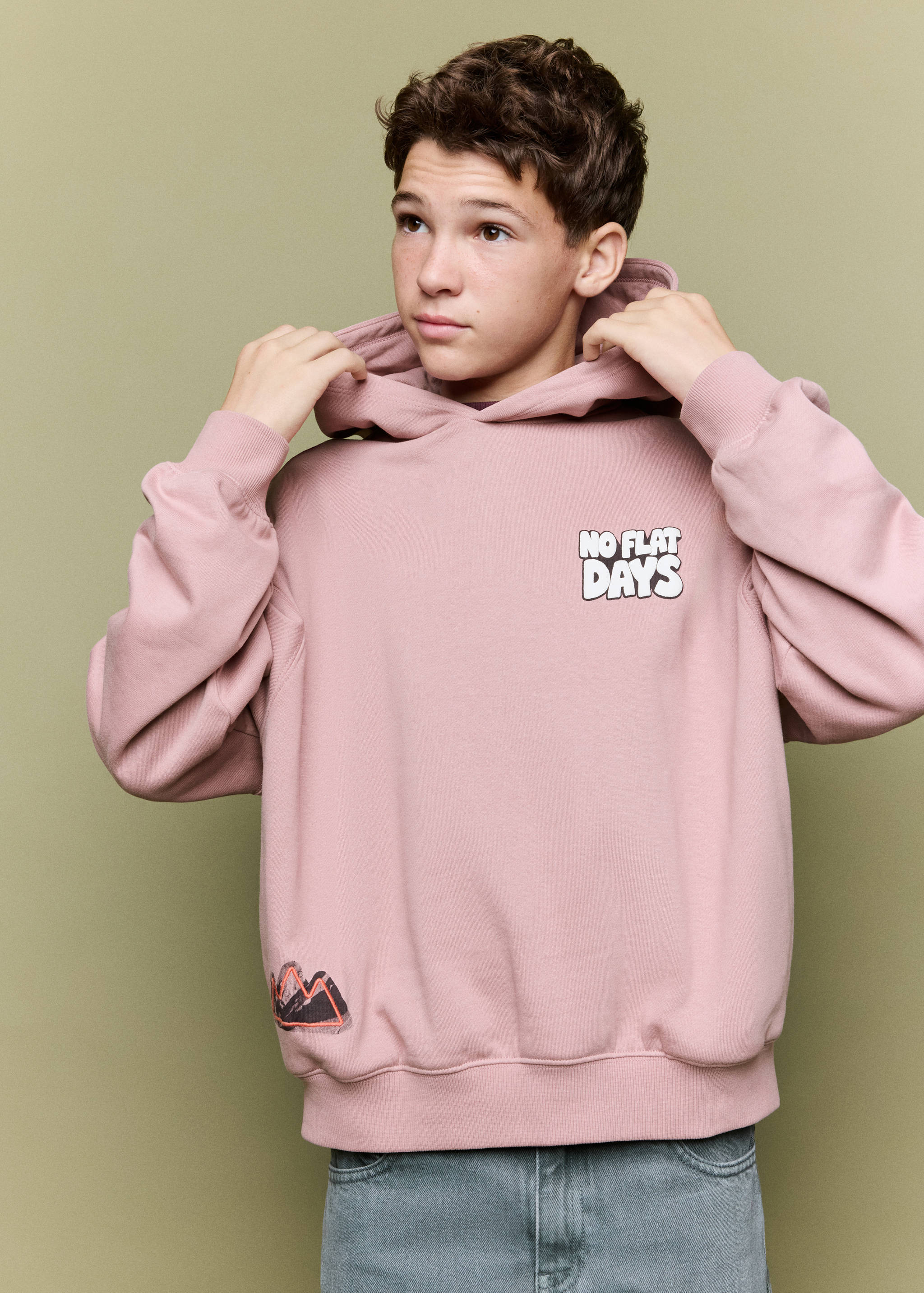 Dusty pink hooded sweatshirt with chest text and hem graphic.