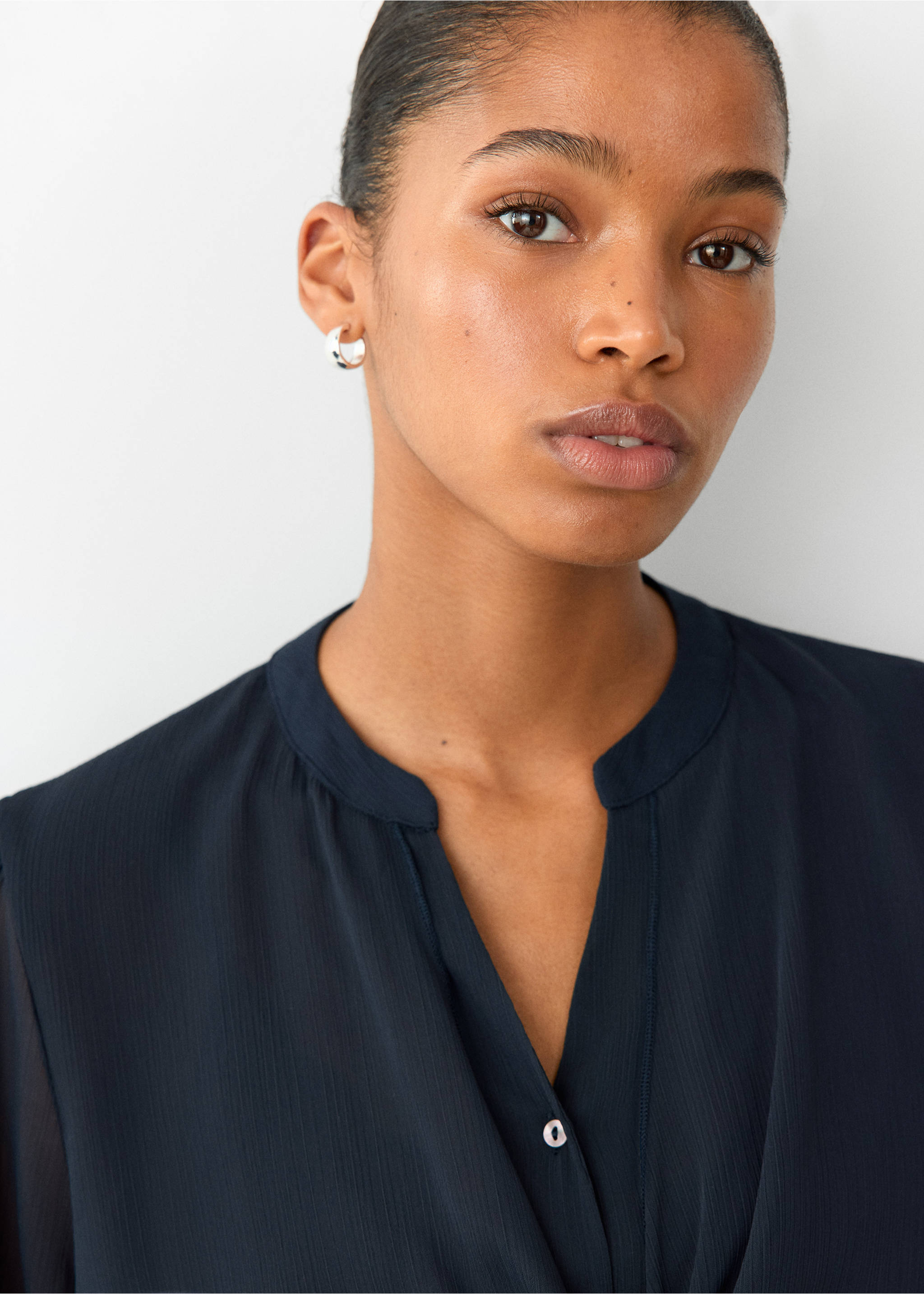 Dark navy blue blouse with a band collar and V-neck slit, shown in a close-up., Navy. Ref: 37037128-00.