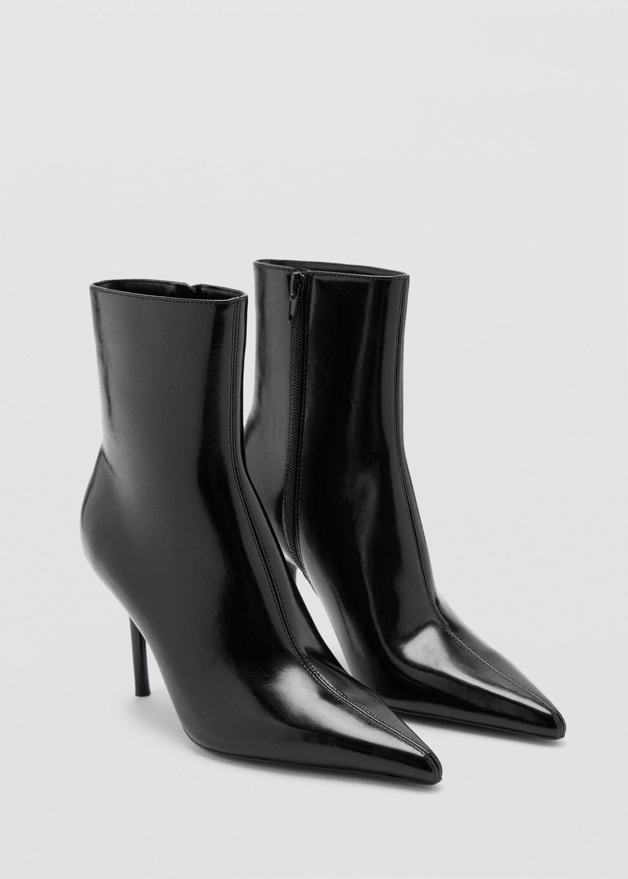 Black patent ankle boots with pointed toes and stiletto heels.