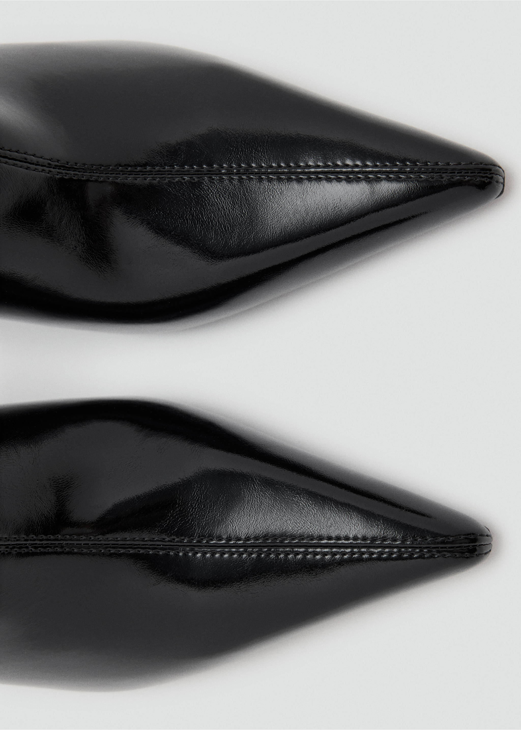 Close-up of black pointed boots showing the toes and glossy finish., Black. Ref: 37037778-00.