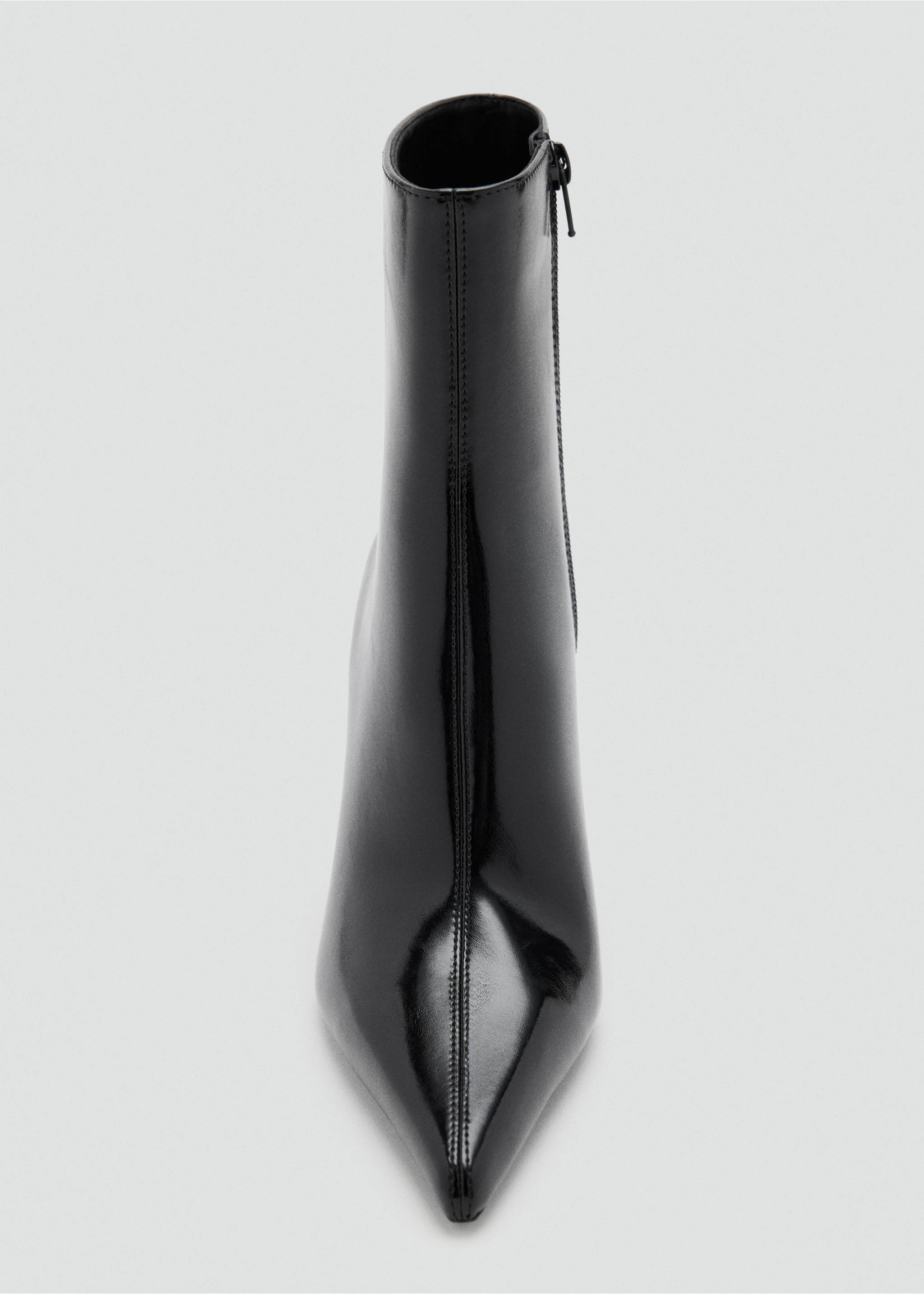 Close-up of a black patent ankle boot with a pointed toe and central seam., Black. Ref: 37037778-00.