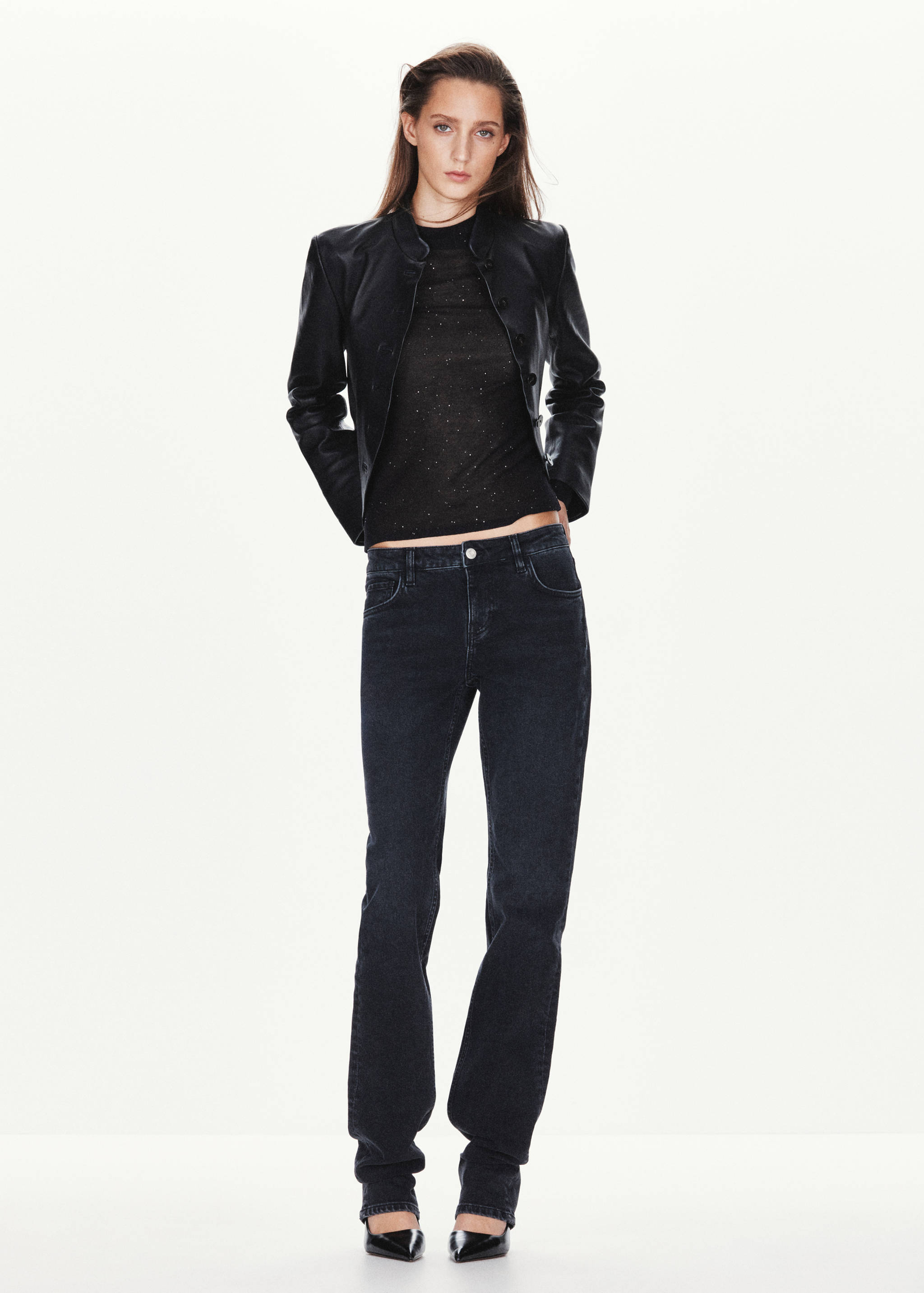 Black sparkly long-sleeve top worn with a black leather jacket and dark jeans.