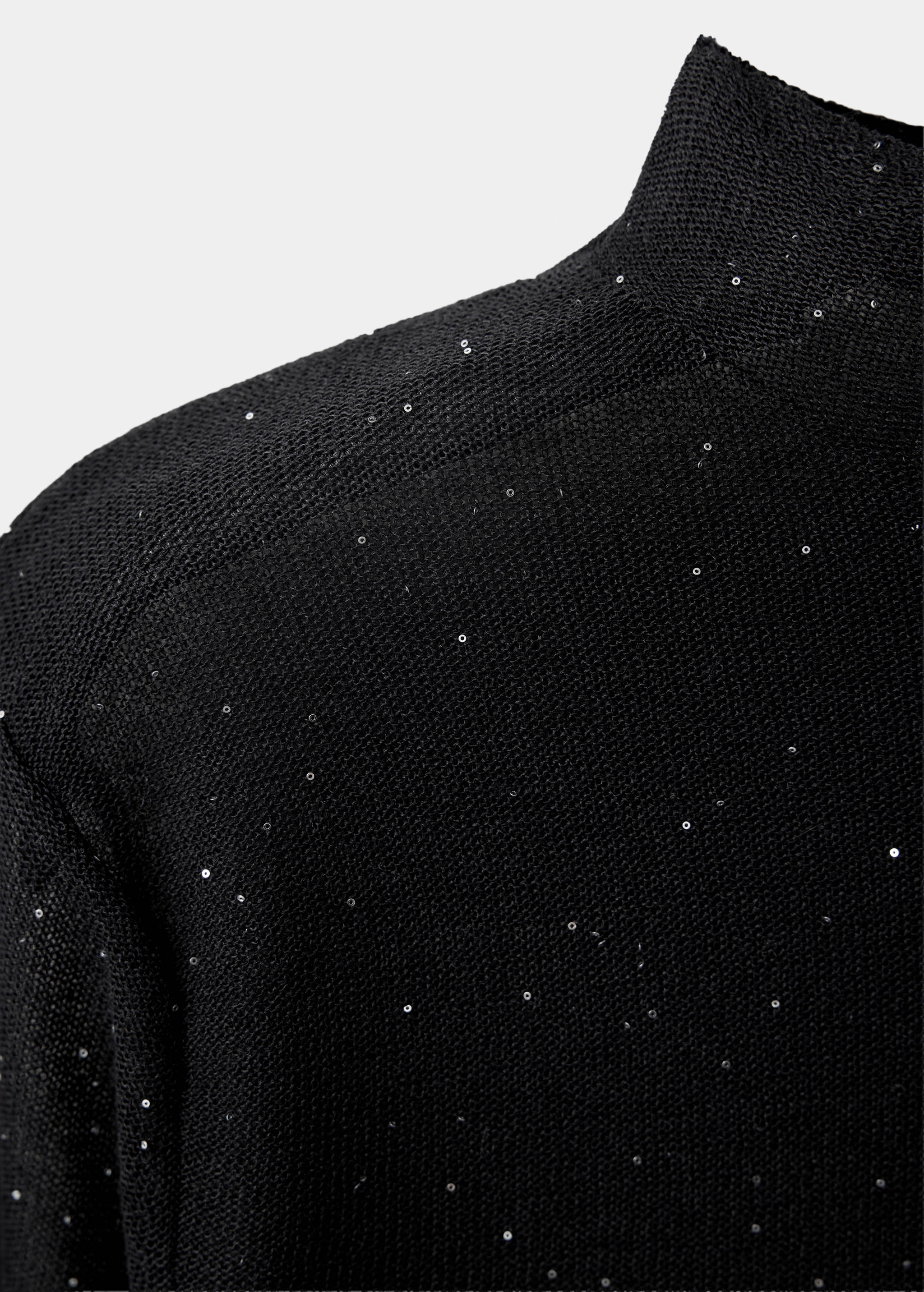 Close-up of a black sequinned high-neck top with a fine knit.
