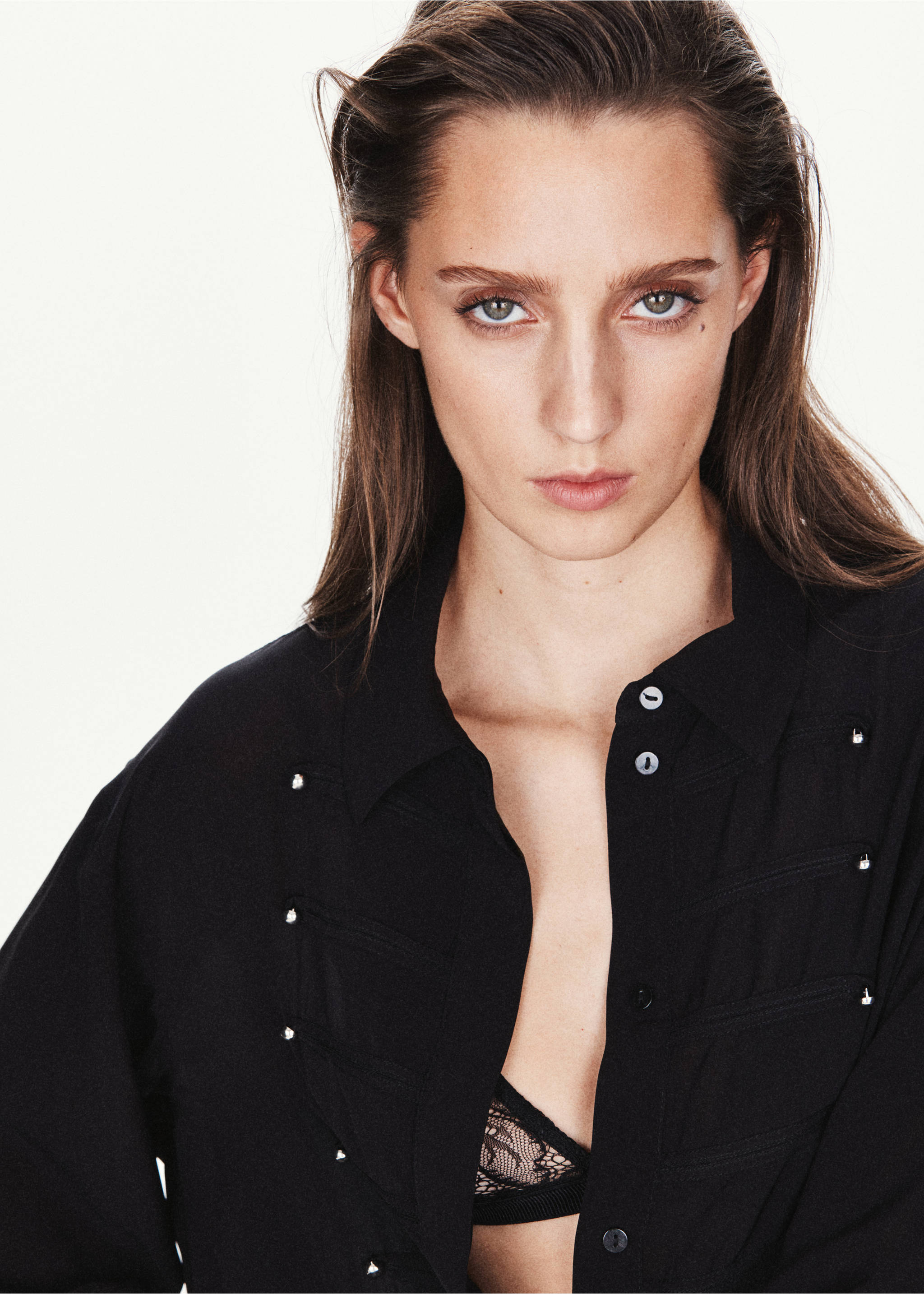 Close-up of a black blouse with decorative silver hardware and collar., Black. Ref: 37037784-00.