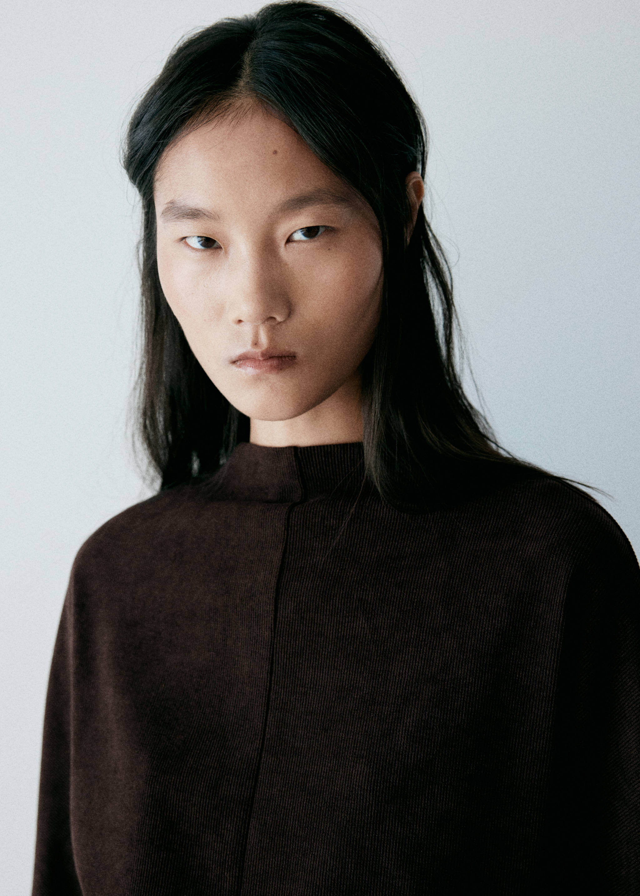 Close-up of a dark brown dress with a mock neck.