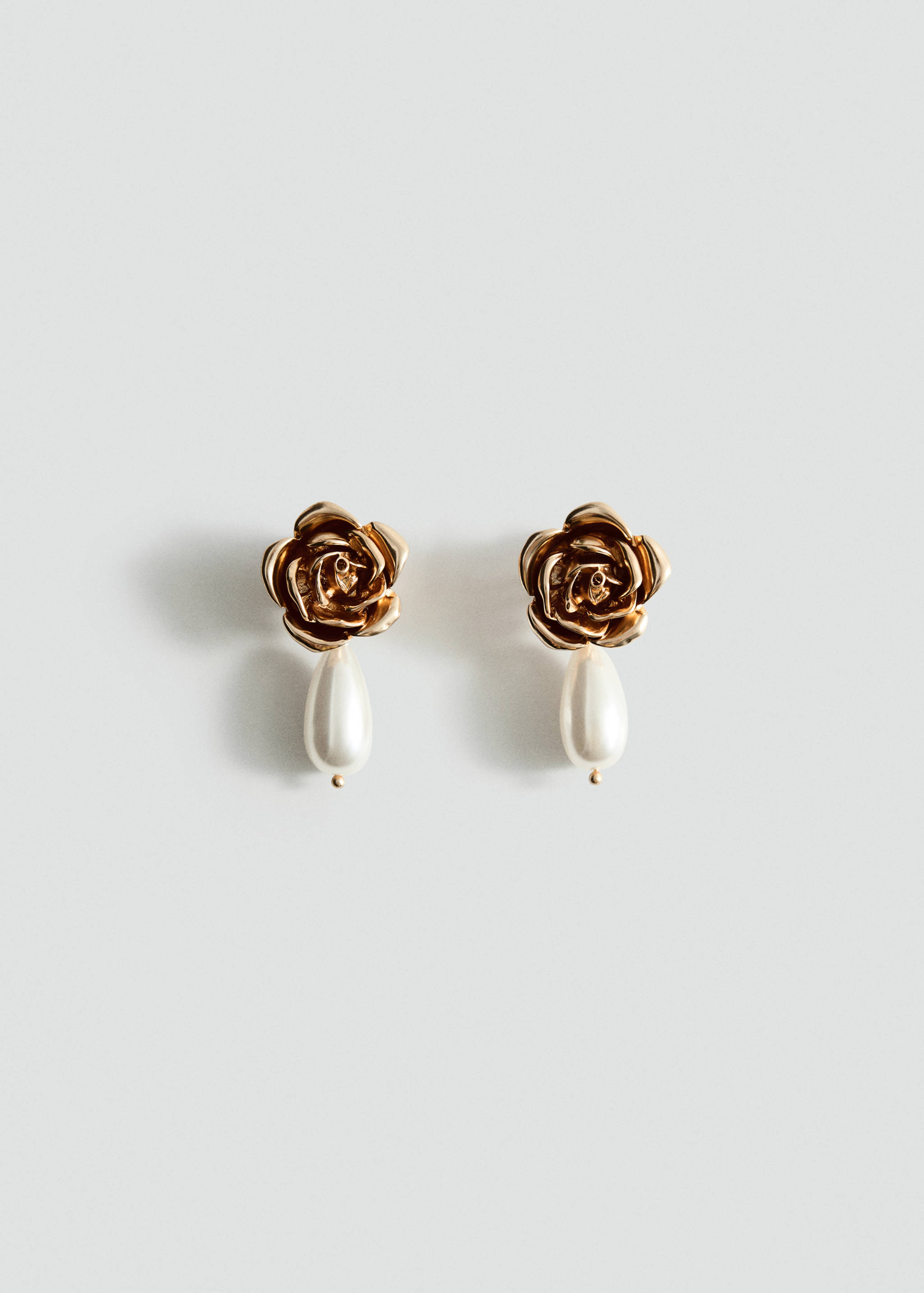 Gold rose earrings with hanging white teardrop beads.