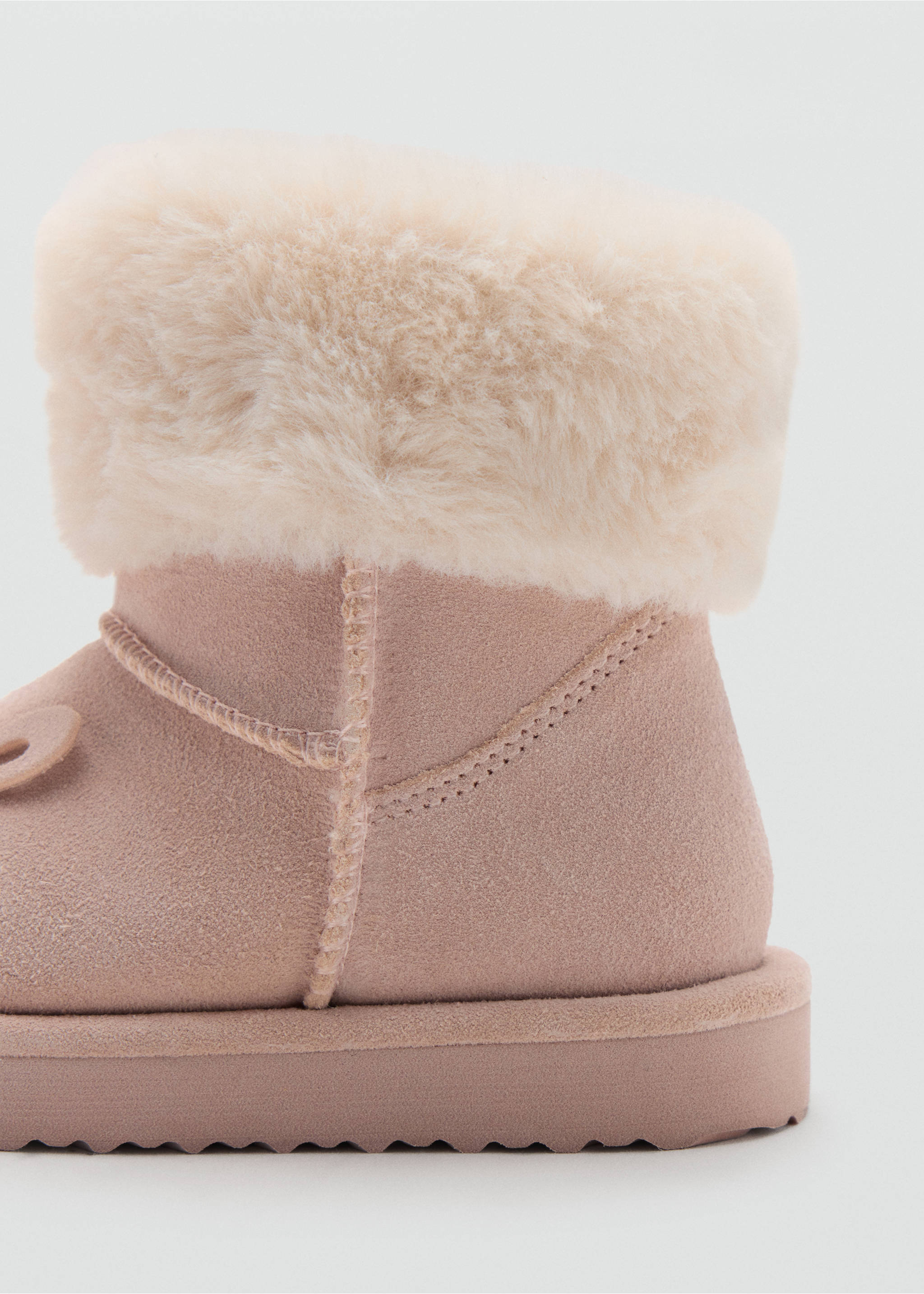 Close-up of a kids' pale pink boot with a cream faux-fur cuff and tonal stitching., Pastel Pink. Ref: 37037799-00.