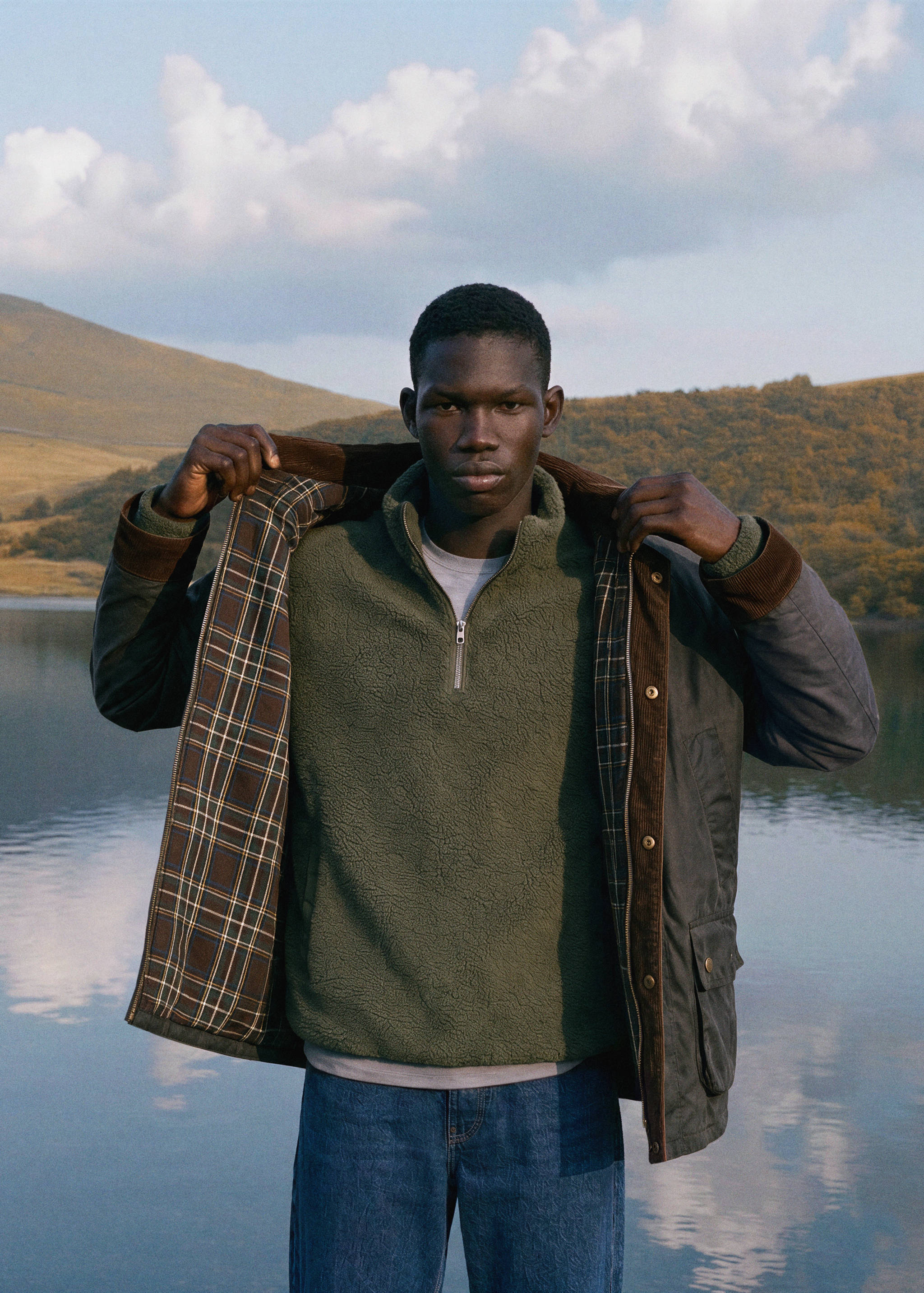Dark green waxed-cotton jacket with corduroy collar, plaid lining and fleece.