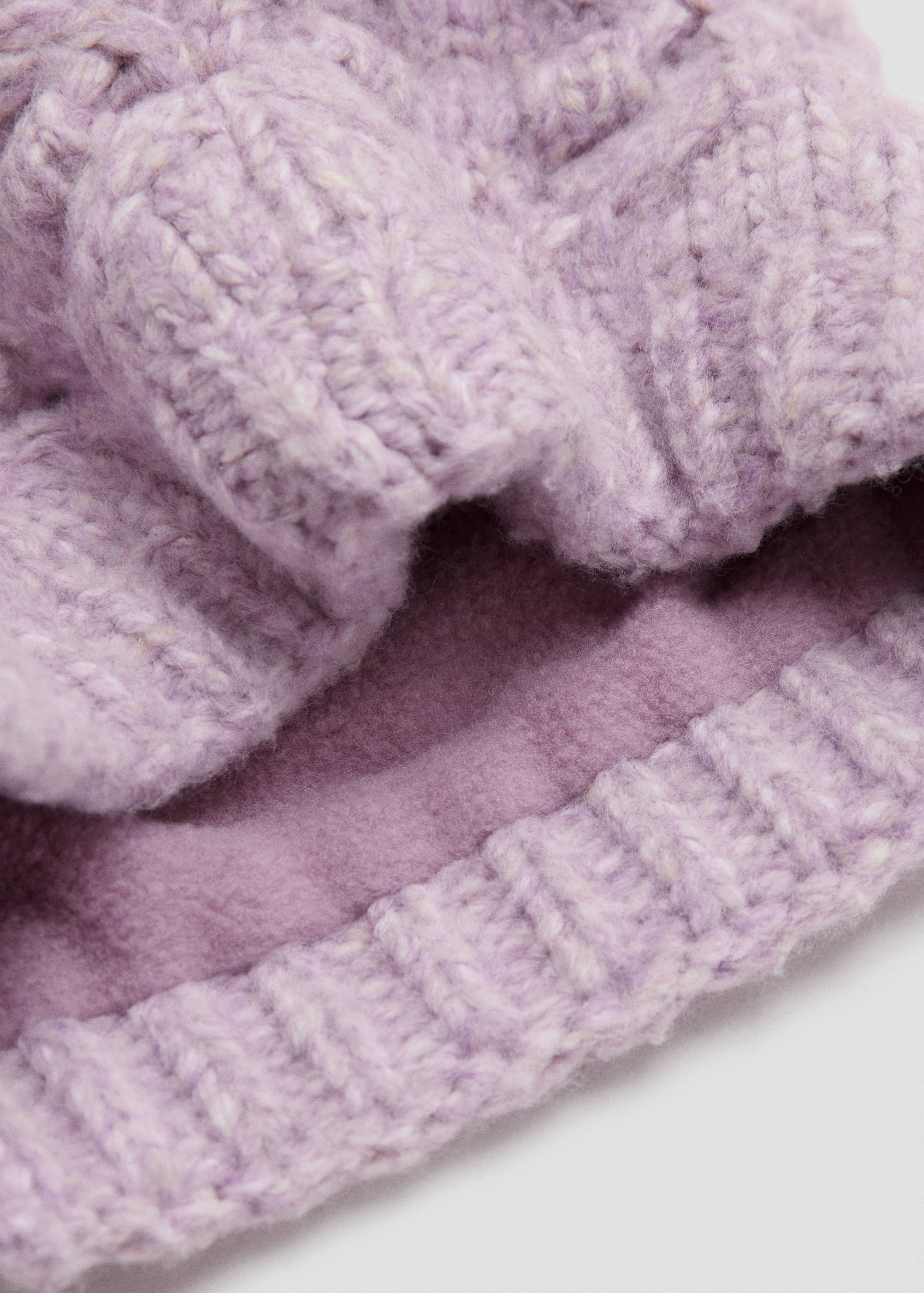 Lilac chunky knit scarf with soft fleece lining in close-up view.