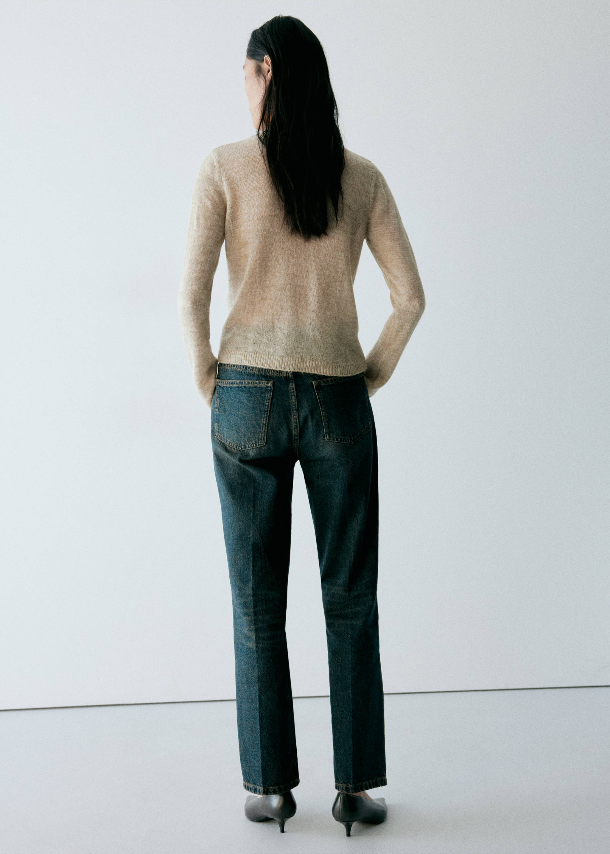 Beige fine-knit cardigan, back view, worn with dark trousers, Pastel Green. Ref: 37037810-01.