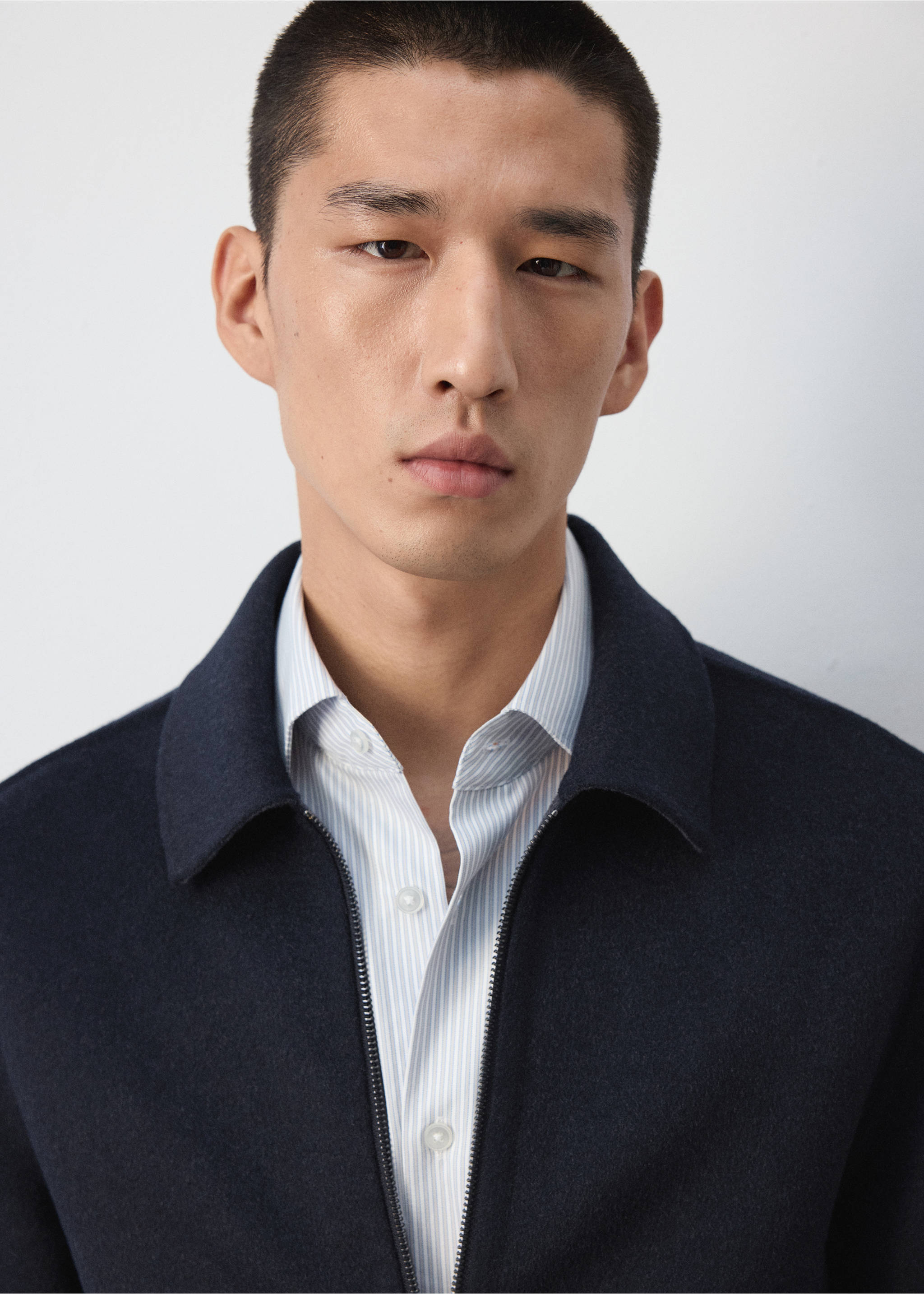 Navy blue zip-up jacket with collar worn over a striped shirt., Night Blue. Ref: 37037885-00.