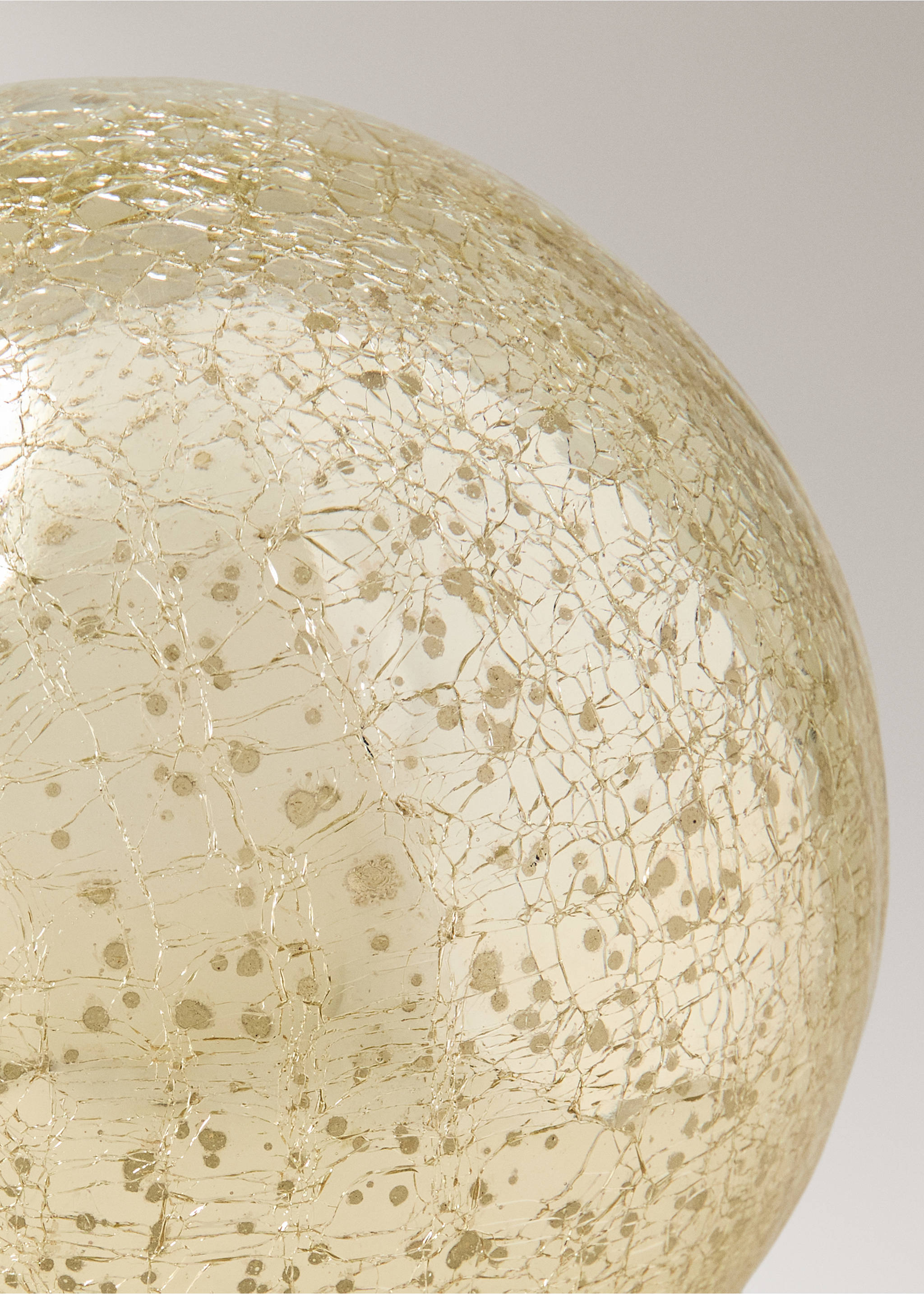Close-up of a round glass Christmas ornament with a gold crackle finish., Gold. Ref: 37037895-00.