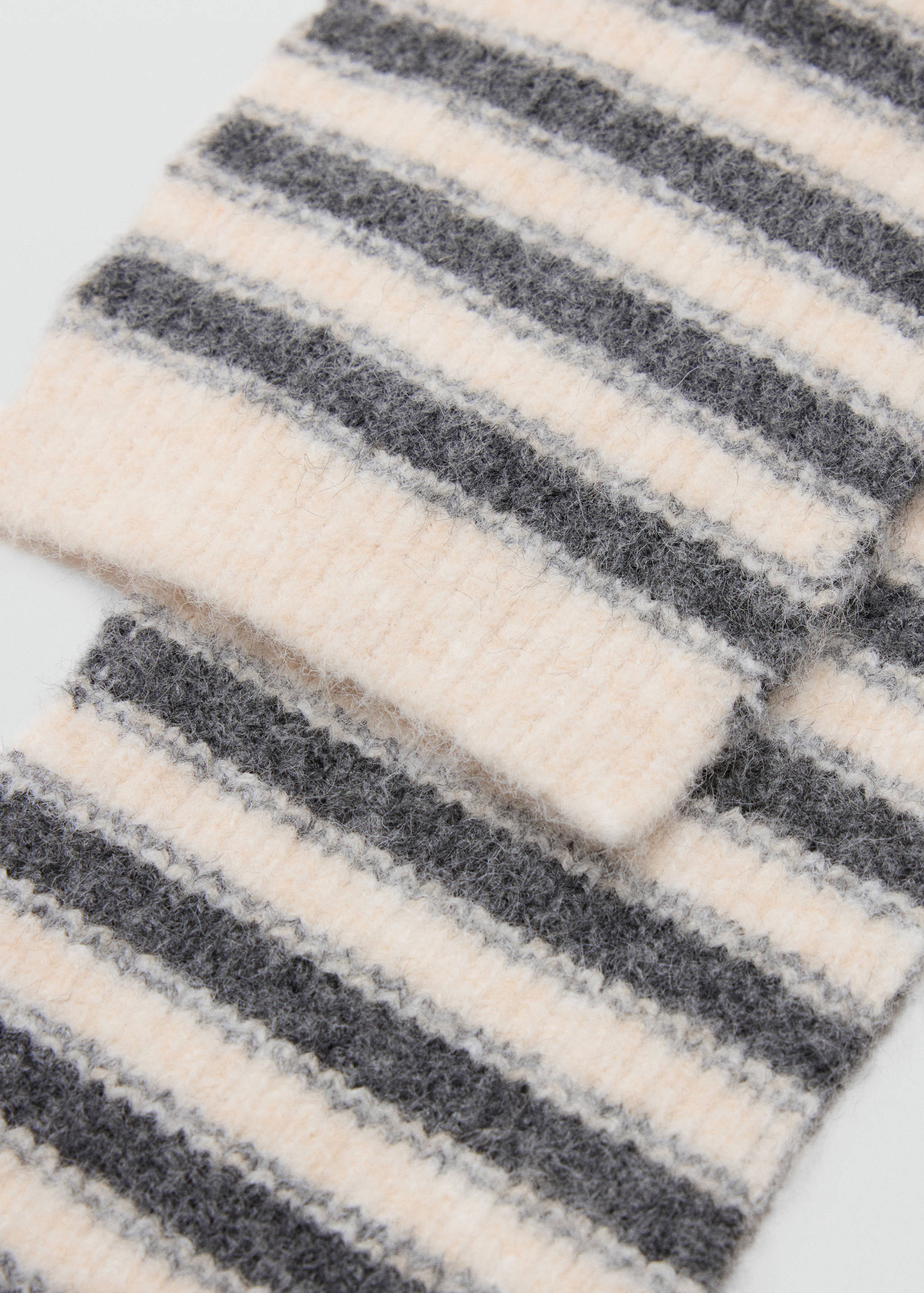 Grey and off-white striped knitted scarf in a fuzzy ribbed texture.
