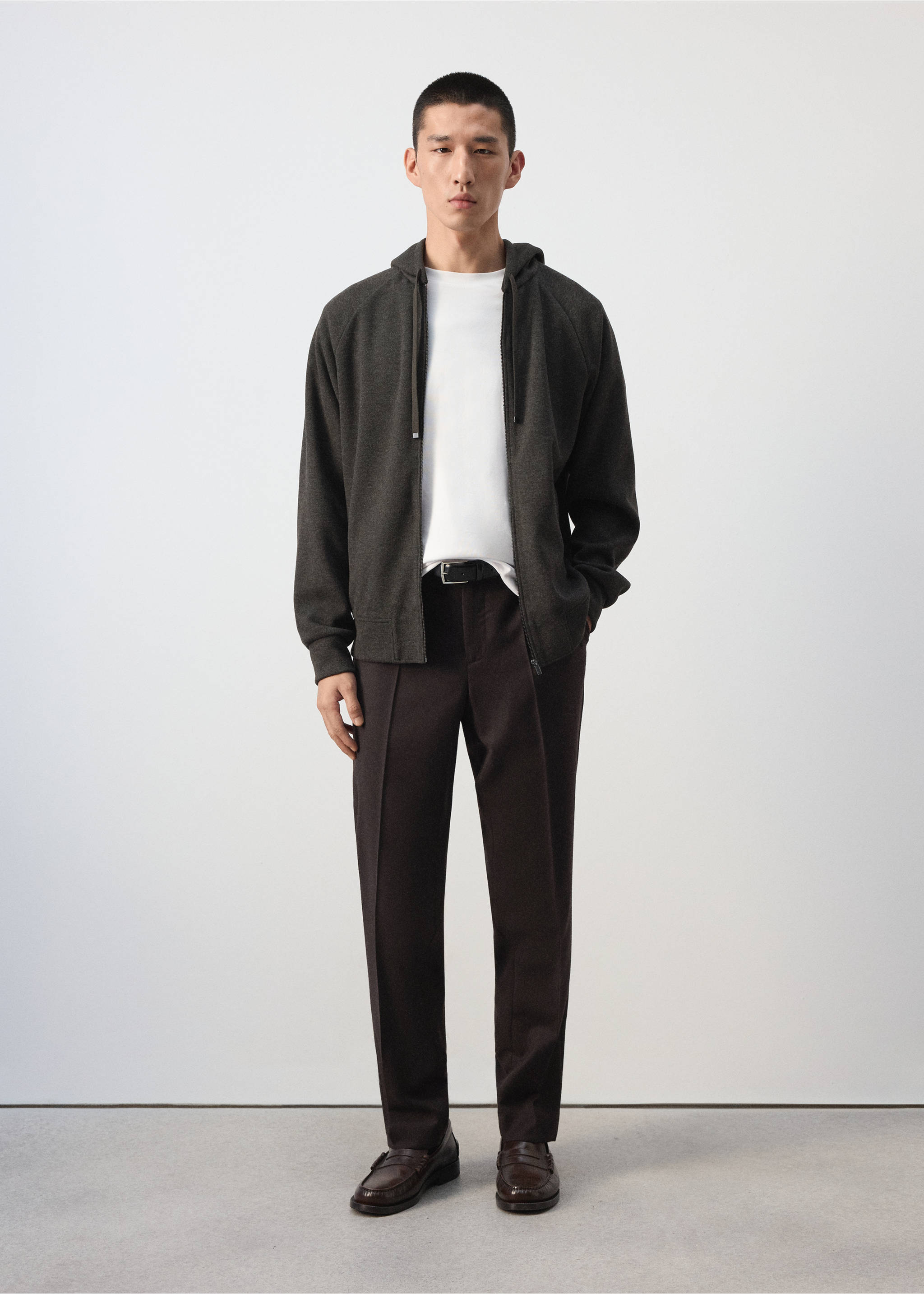 Dark grey zip-up hoodie worn open over a white t-shirt with dark brown trousers., Brown. Ref: 37037899-00.