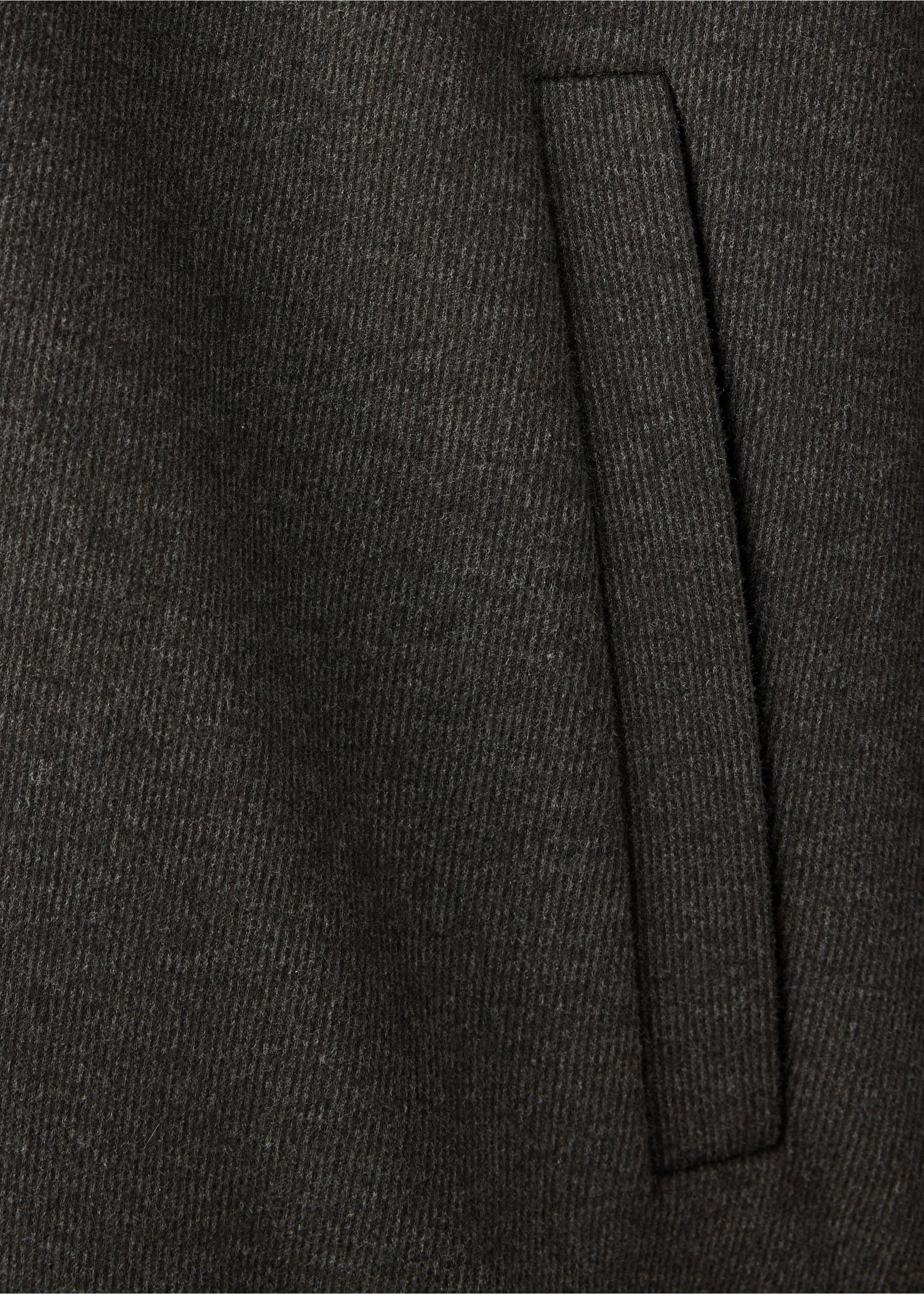 Close-up of the dark grey textured fabric and pocket detail on a sweatshirt., Brown. Ref: 37037899-00.