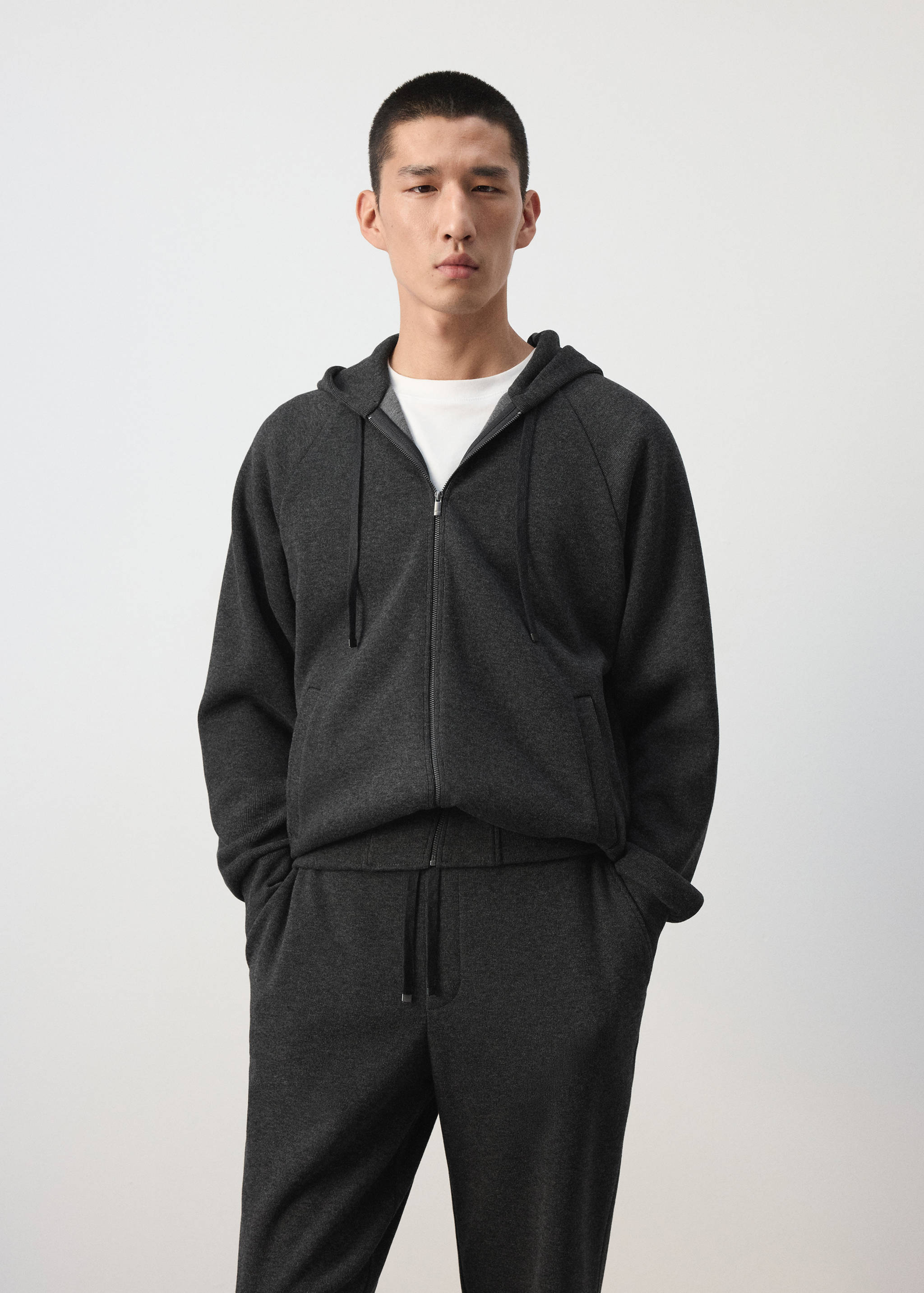 Dark grey zip-up hoodie in a relaxed fit with a drawstring hood.